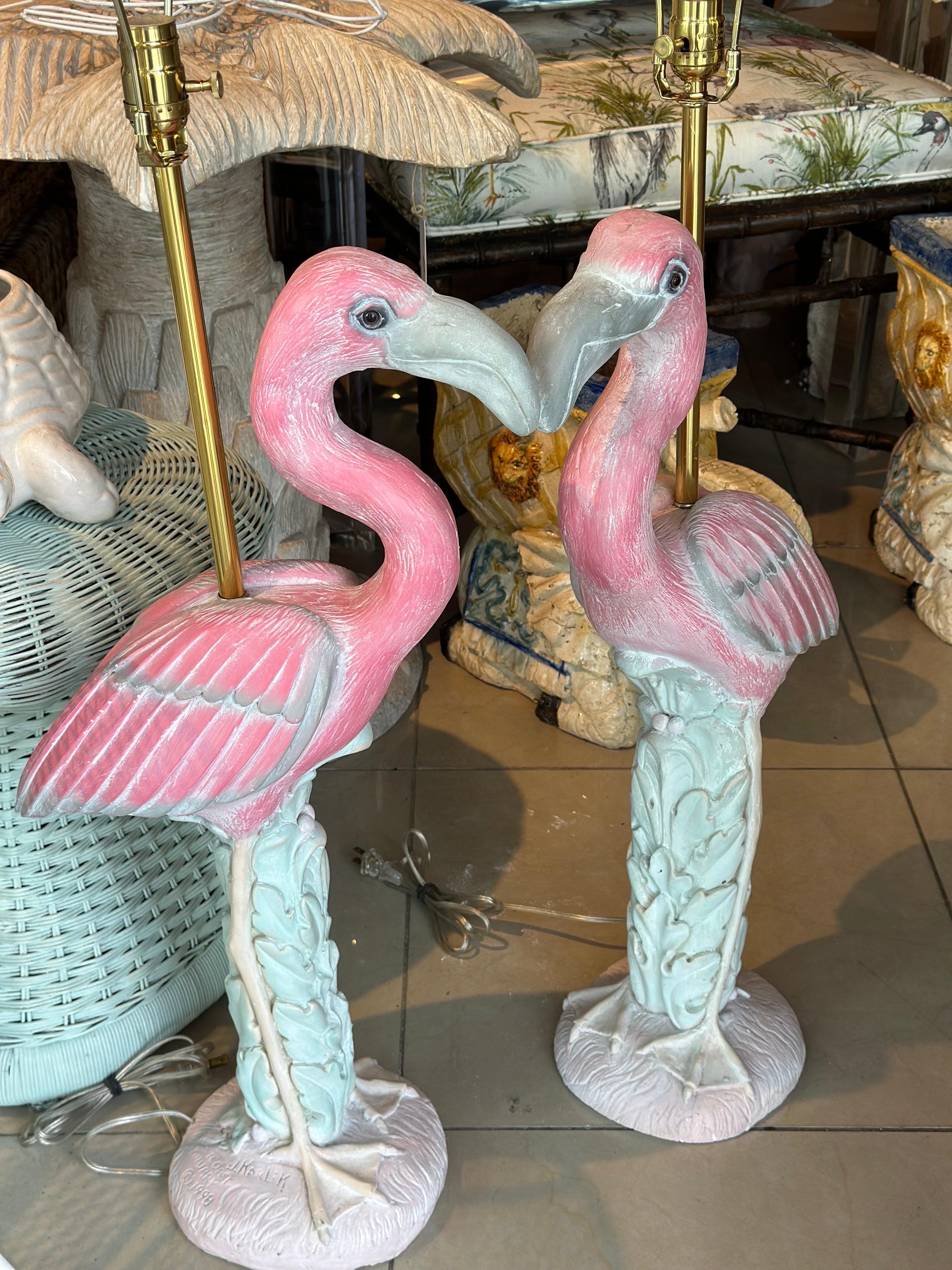 Amazing pair of vintage plaster flamingo table lamps. These have been newly wired, clear cord, 3 way sockets, brass hardware. No chips or breaks. Dimensions: 40 H (to top of finial) x 34 H (to top of socket) x 16 D x 8 W. Signed and dated  on the