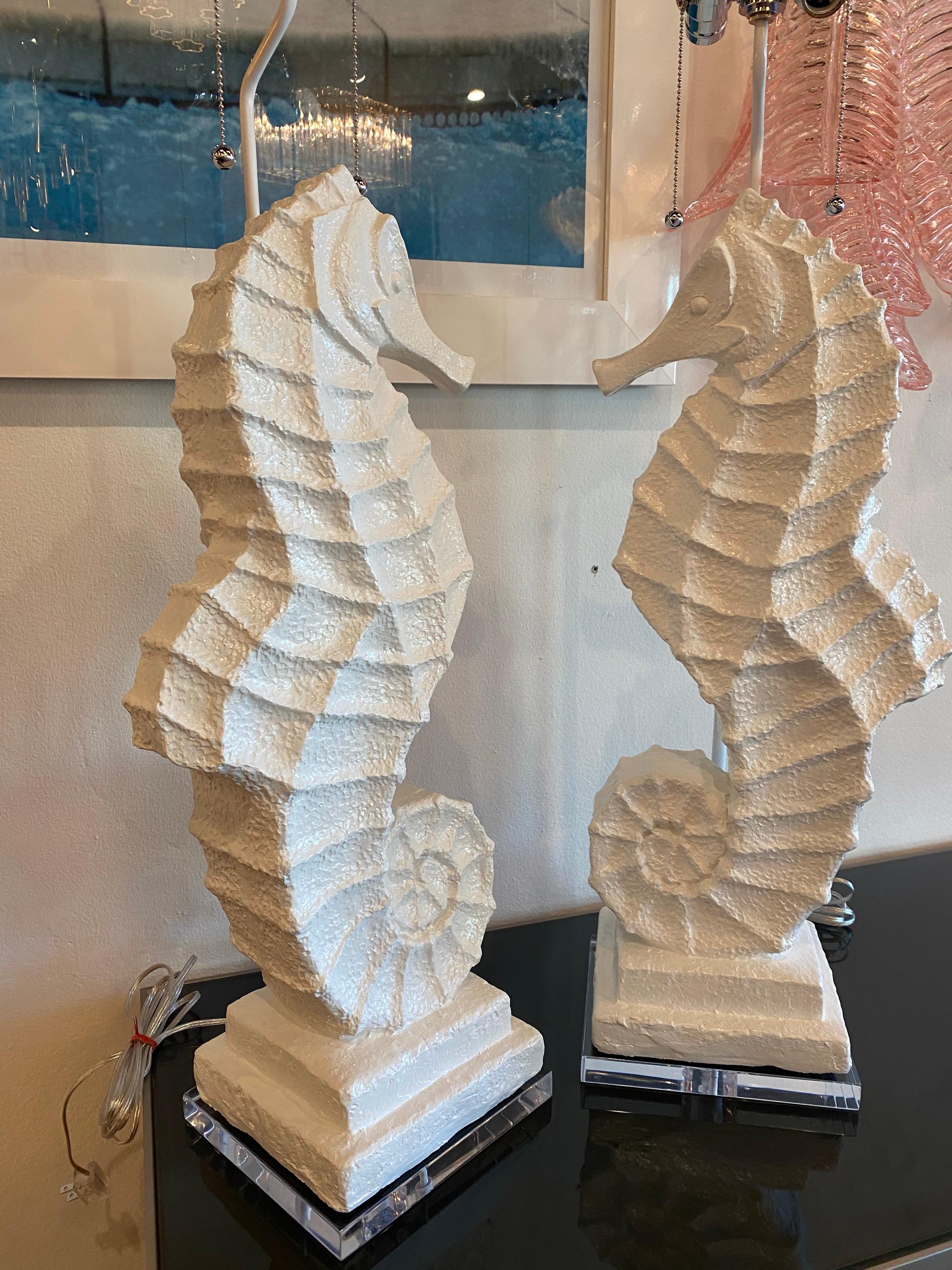 The most amazing large pair of one of a kind, custom made seahorse lamps. Vintage large opposing plaster seahorses that have been lacquered white and made into lamps. Lucite base, double socket pull chain nickel sockets, all new wiring and topped