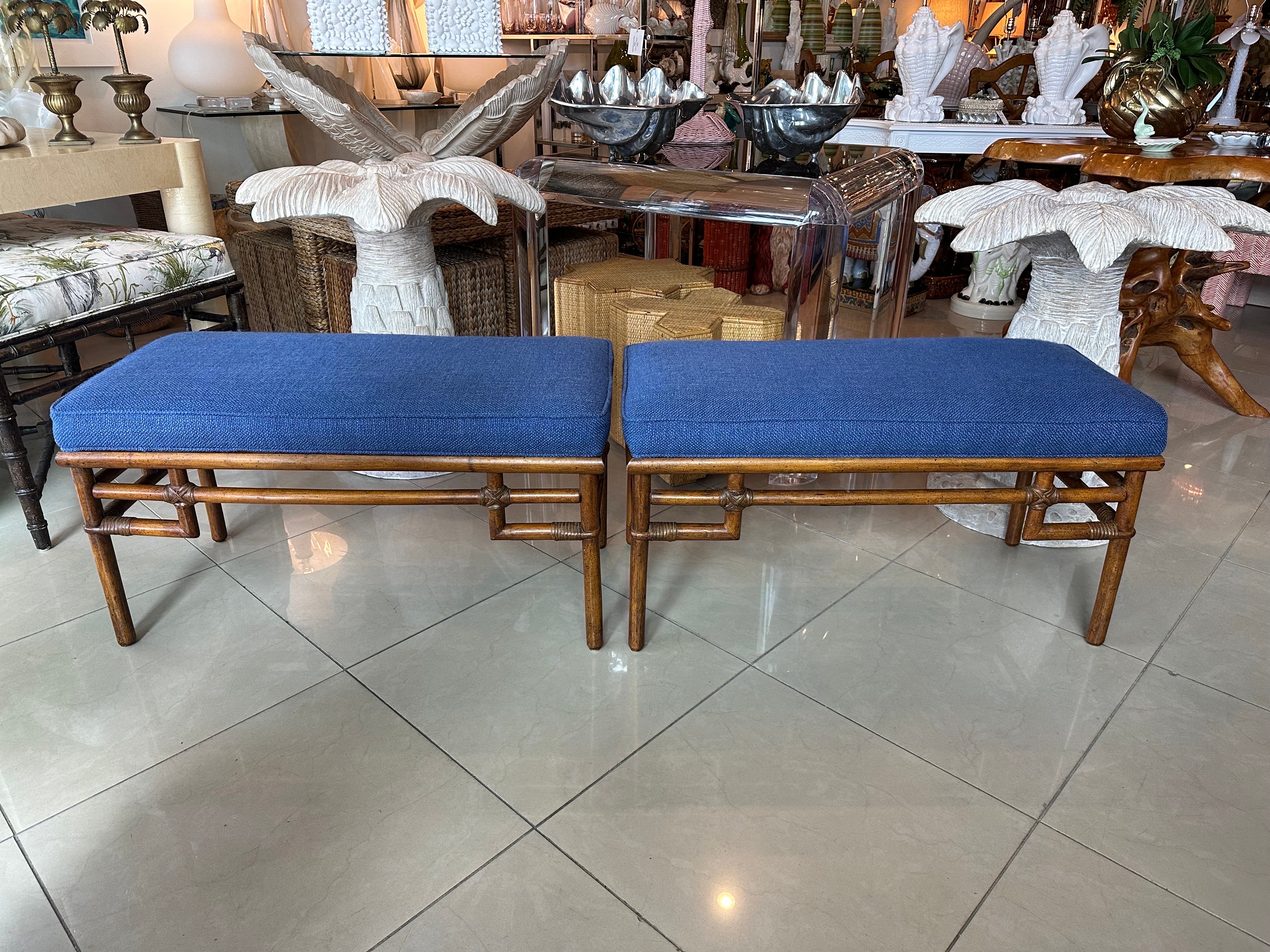 Vintage pair of rattan, bamboo end of bed benches. Made by Ficks Reed. Original upholstery has been cleaned but may show minor wear. Dimensions: 18.5 H x 35 L x 16 D. 