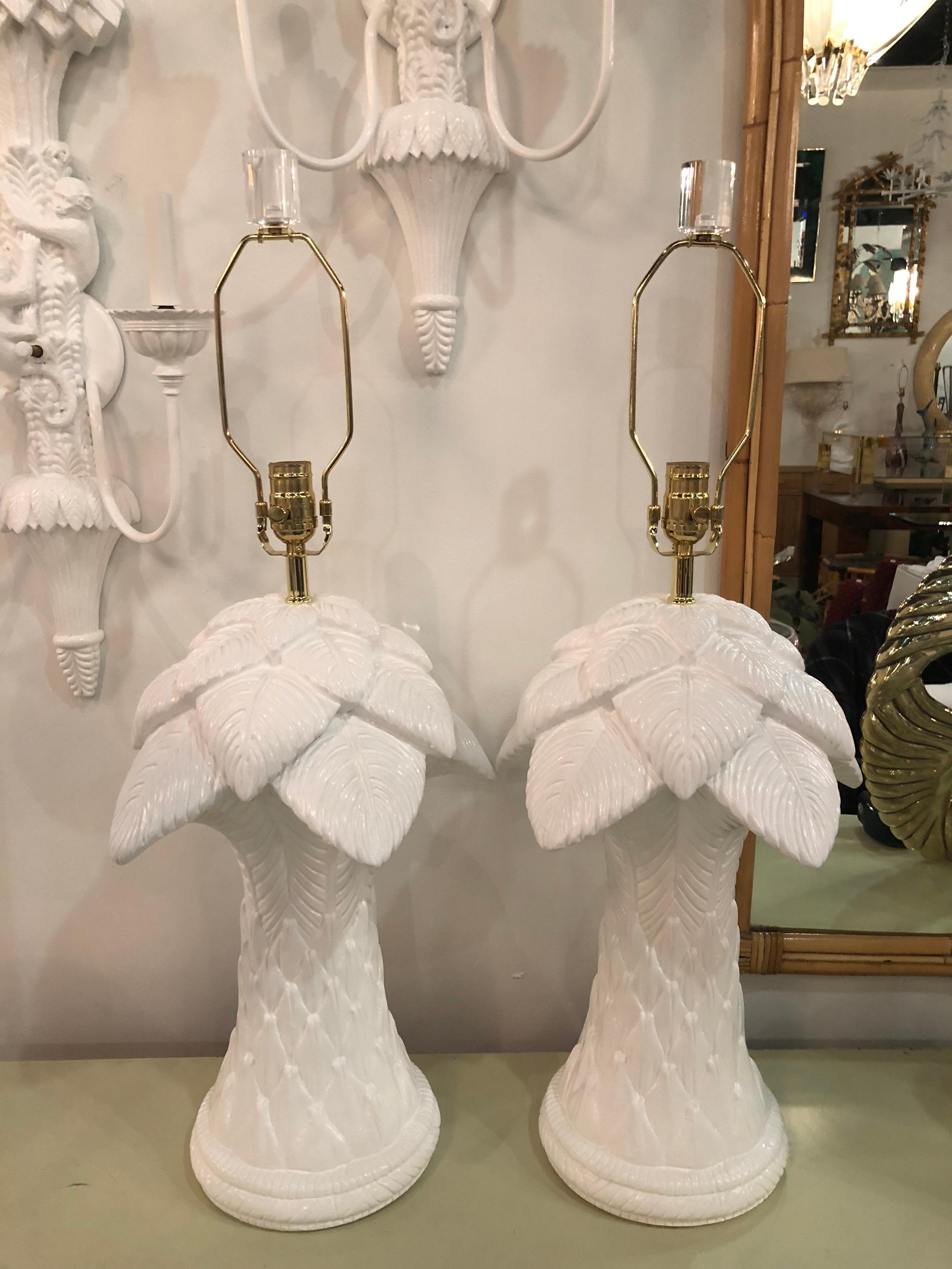 Amazing pair of vintage plaster palm tree frond leaves leaf table lamps. These have meticulously restored. Professionally lacquered in a white gloss finish. Newly wired with new brass hardware. Lucite finials. These are very heavy. Perfect for the