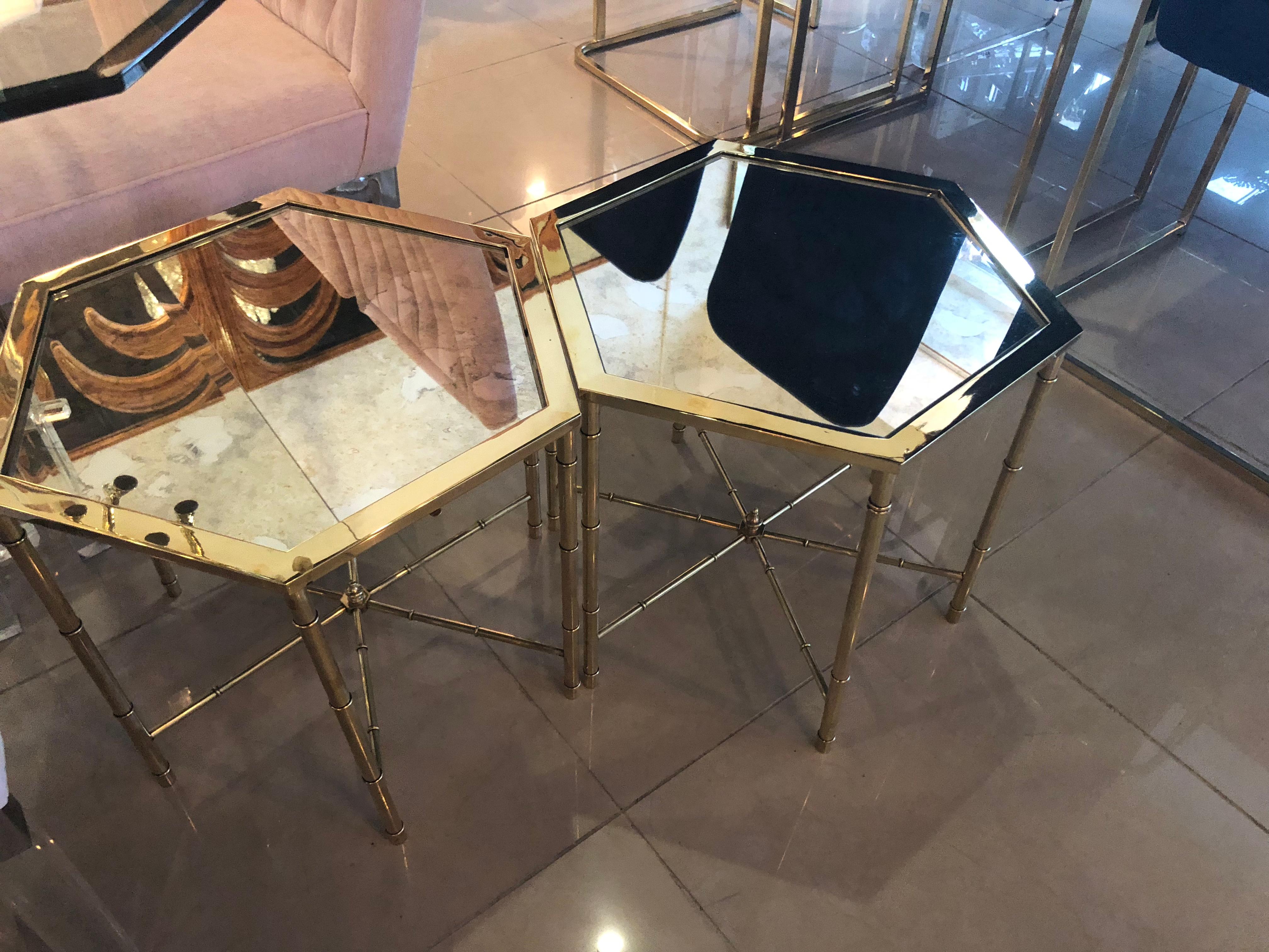 Vintage pair of octagonal brass Mastercraft end side beverage tables. These have been professionally polished and have beautiful antique mirror places in them. Absolutely gorgeous!
 