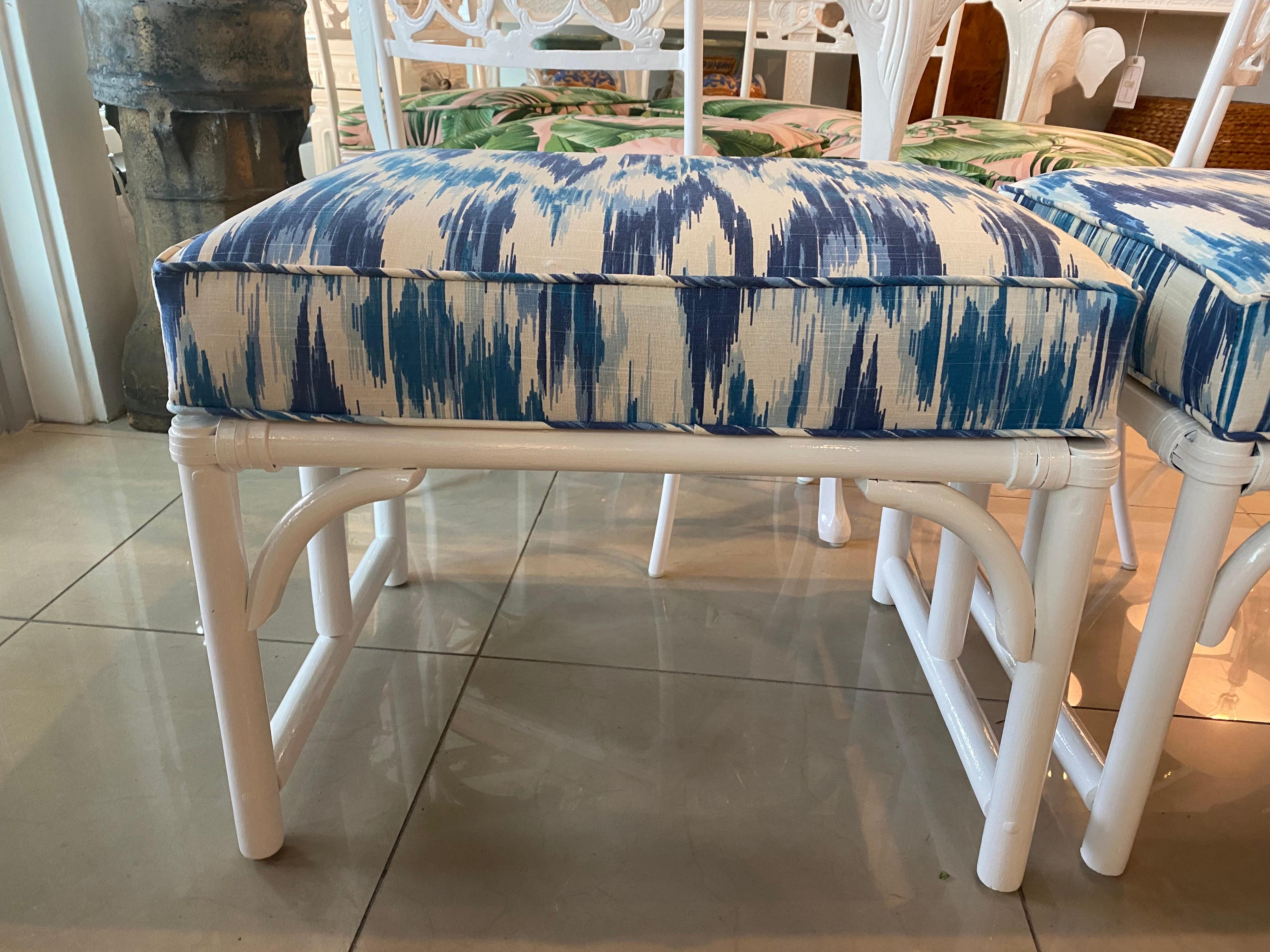 Beautiful pair of vintage rattan bamboo stools benches ottomans. These have been newly lacquered white gloss. Newly upholstered blue and white fabric with all new insides, foam as well.
