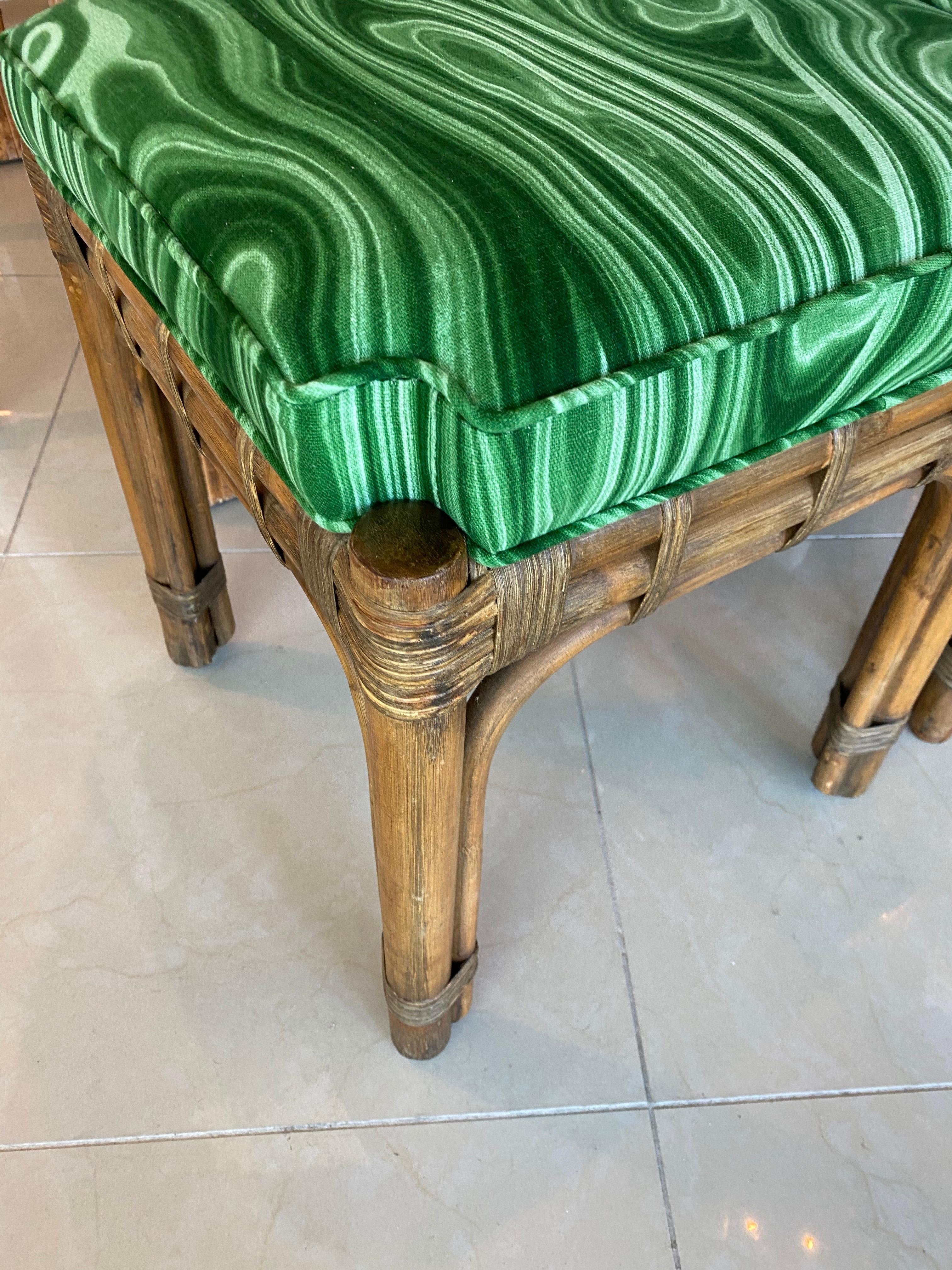 Lovely vintage pair of rattan stools benches. These have been upholstered in a green malachite fabric. The foam inside the cushion is new as well.