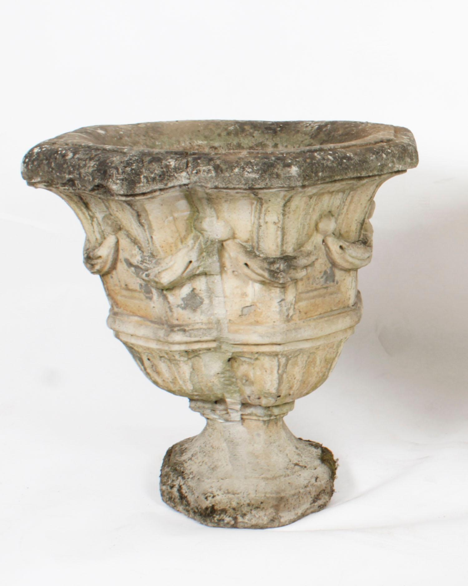 A decorative Vintage pair of reclaimed weathered composition garden urns dating from the mid 20th Century.

Condition:
In good condition. As vintage items, the pieces show signs of use commensurate with age, these minor condition issues are