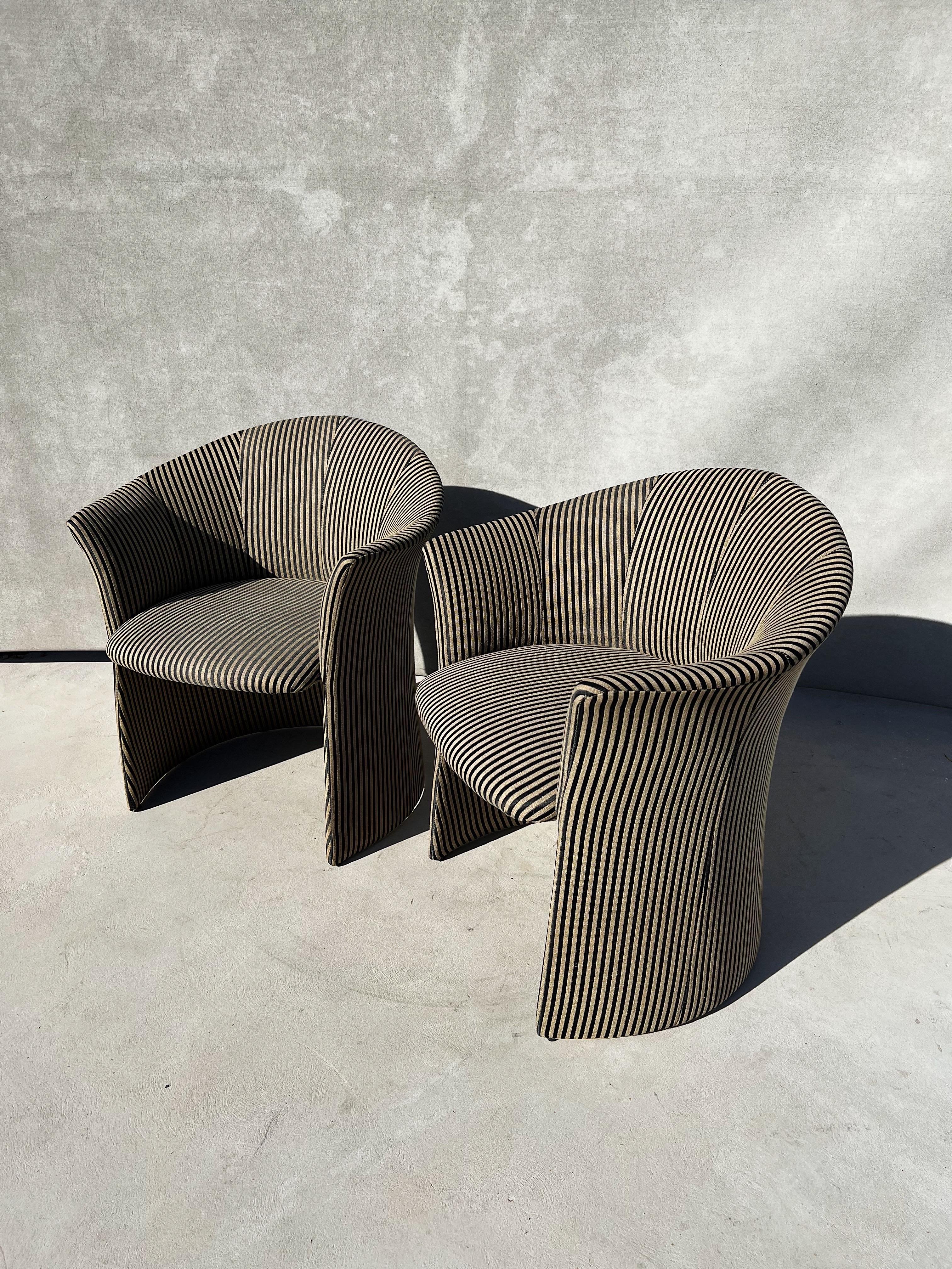 A vintage modern pair of sculptural club chairs, upholstered in a traditional striped fabric.

Each chair is sophisticated, elegant, fashionable and quite the statement to add to any room.

The upholstery was custom designed, inspired by the