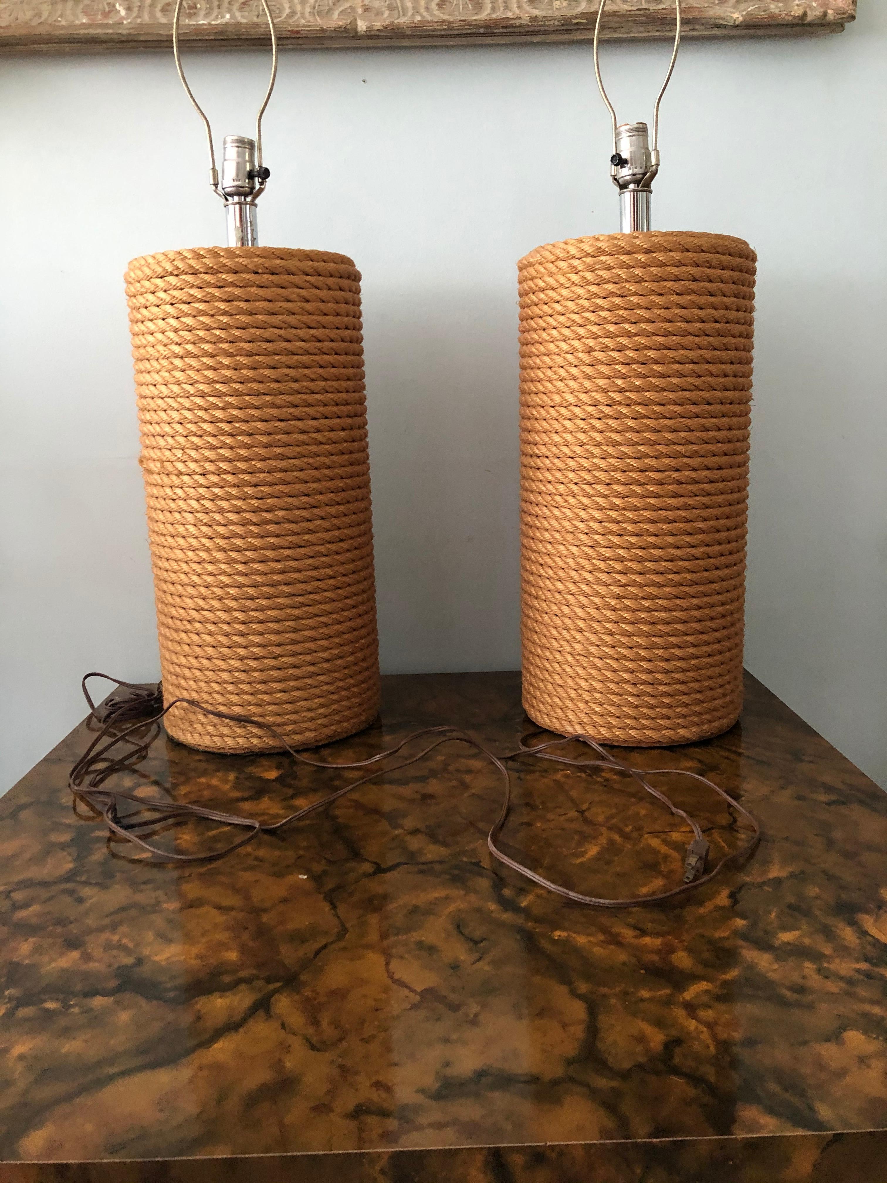 Fantastic pair of vintage rope lamps. Probably from the 1960s or 1970s. The lamps measure 20 inches high to the top of rope, and 32 1/2 inches to top of finial. They are 9 1/2 inches wide and deep.
