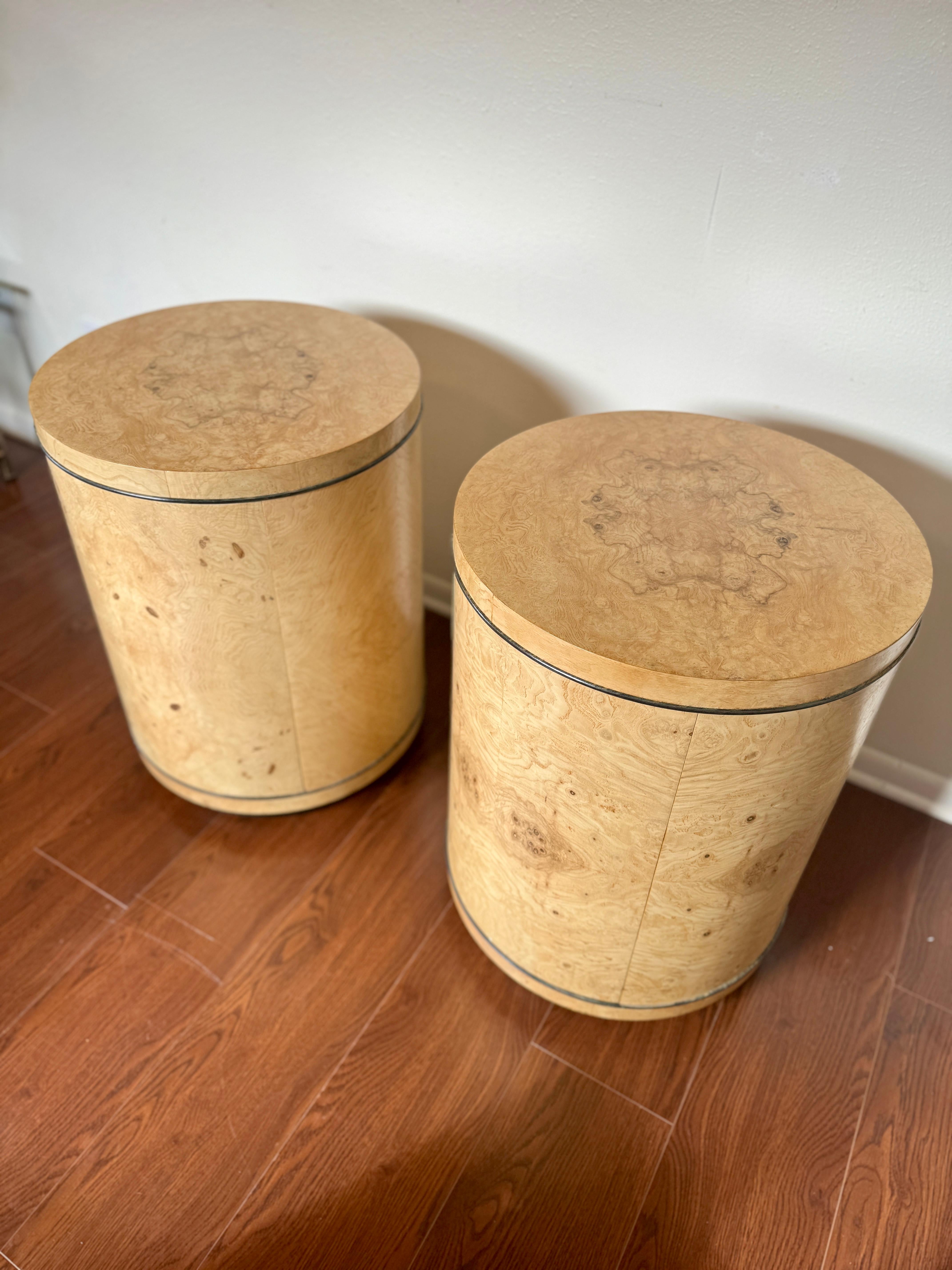 Vintage pair of Scene II burl side tables by Henredon, circa 1980s. These side tables are drum shaped with olive wood burled veneer and contain a 