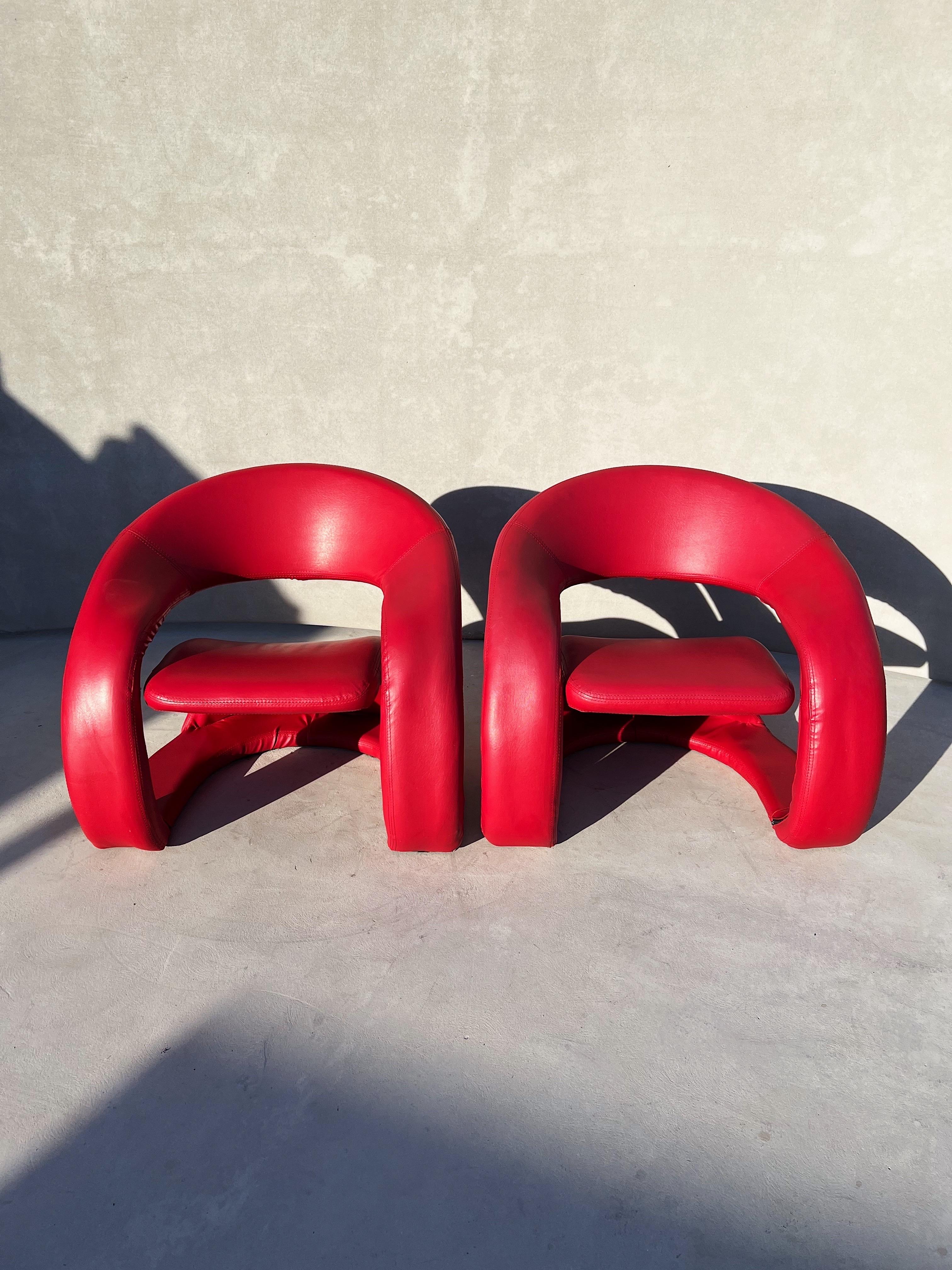 Vintage pair of sculptural chairs in electric red, Attributed to Jaymar

A vintage pair of lounge chairs in a sculpturally eye-pleasing design and form 

These chairs were created sometime in the 1990s, custom made in an electric pop red