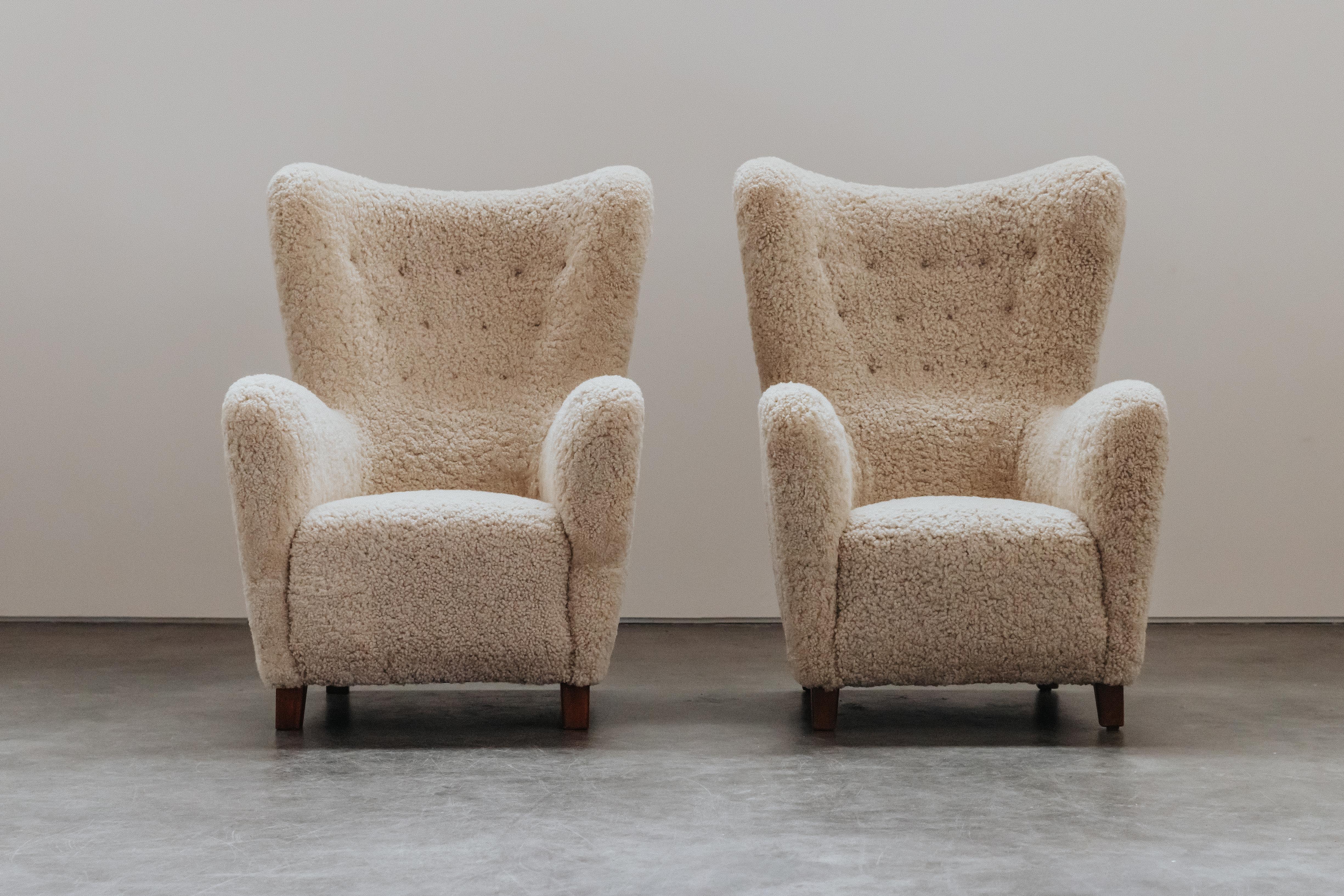 Vintage Pair Of Shearling Cabinetmaker Chairs From Denmark, Circa 1950.  Very comfortable model, later upholstered in real shearling. Excellent condition.