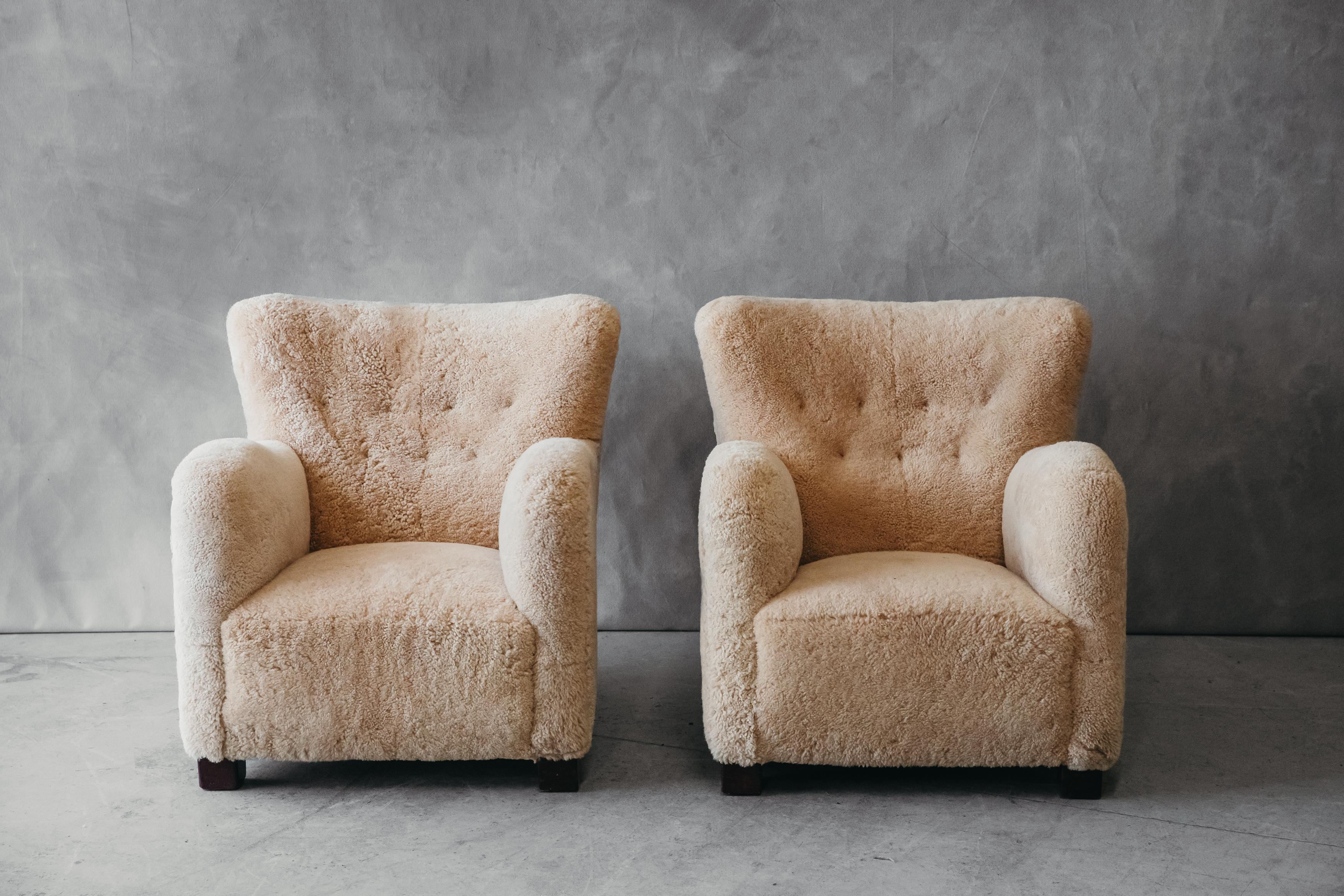 Vintage pair of shearling cabinetmaker chairs from Denmark, Circa 1960. Very comfortable model, later upholstered in honey color shearling. 

We don't have the time to write an extensive description on each of our pieces. We would love to chat