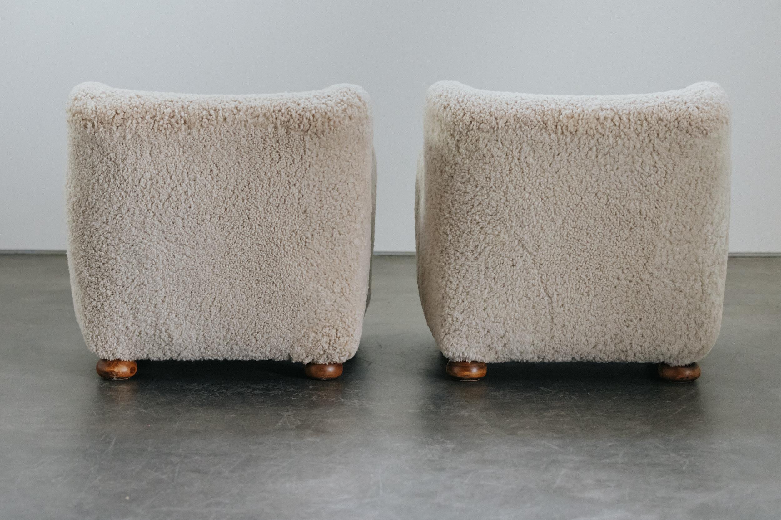 Vintage Pair Of Shearling Cabinetmaker Lounge Chairs From Denmark, Circa 1950.  Rare model with nice doughnut shaped feet.  Later upholstered in Denmark in very soft shearling.  Excellent condition.