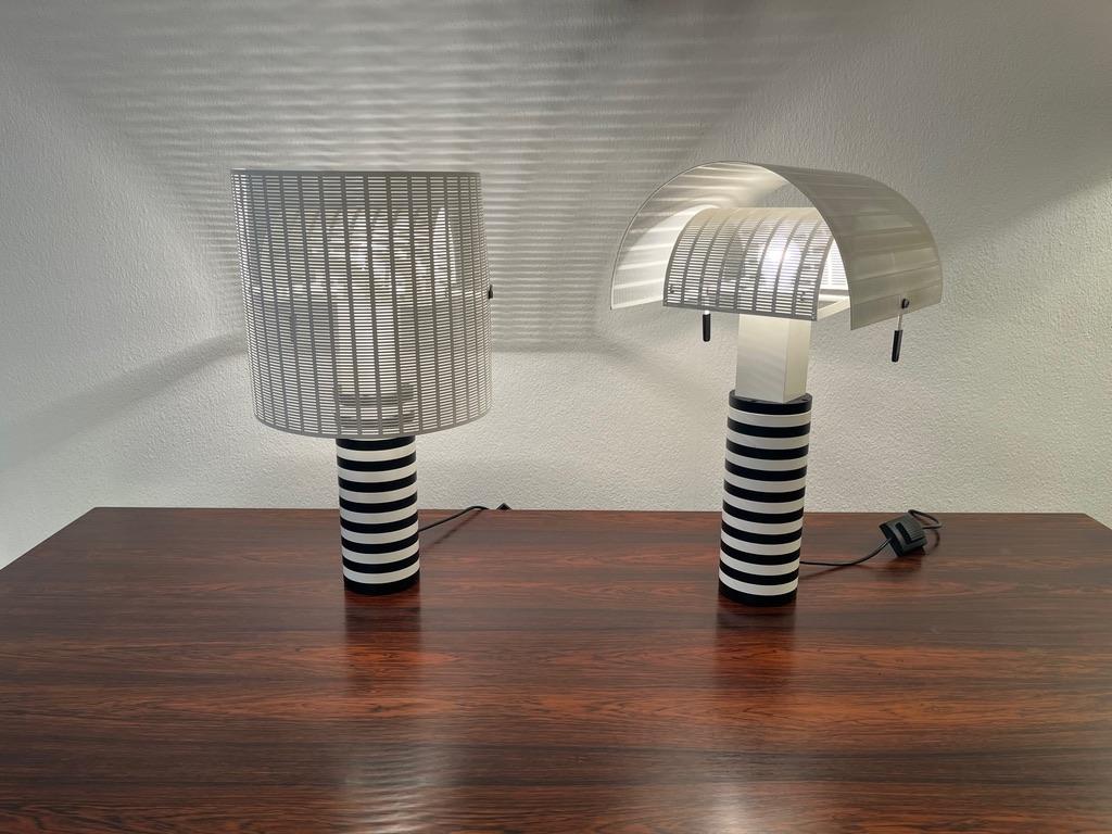 Vintage pair of Shogun table lamps by Swiss architect Mario Botta for Artemide Milano ca. 1980s.
Adjustables perforated metal shades allows to create different lighting effects.
Each lamp signed Mario Botta, Shogun, Artemide, Made in Italy.
1