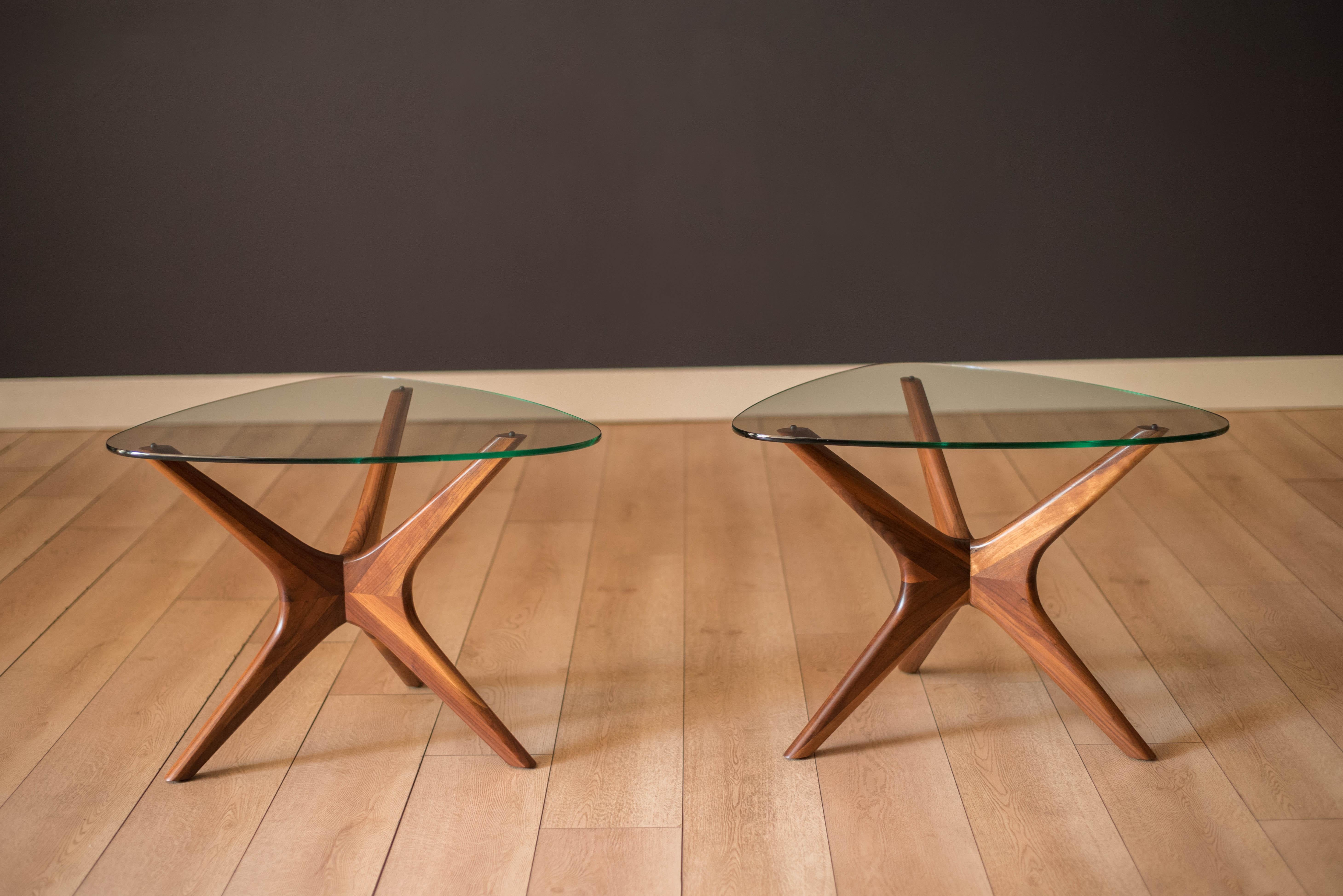 Mid-Century Modern pair of side tables designed by Adrian Pearsall for Craft Associates, circa 1960s. The supporting base is made of sculptural solid walnut with a curved triangular glass top. Price is for the pair. The matching coffee table is
