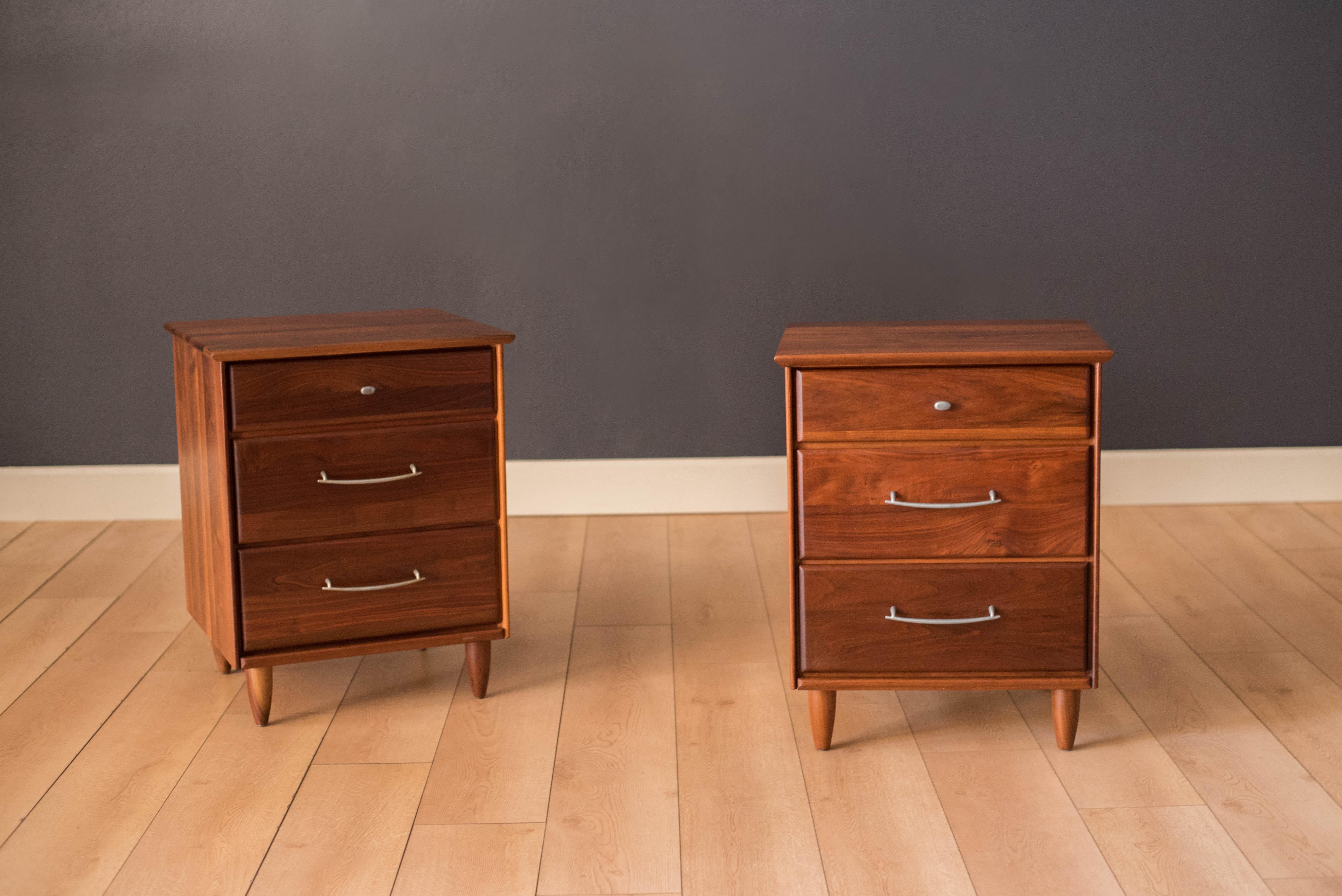 Mid-Century Modern pair of nightstands or bedside tables by ACE-HI Furniture, California. This set is made of solid planked walnut and includes three storage drawers with pewter handles. Price is for the pair.
