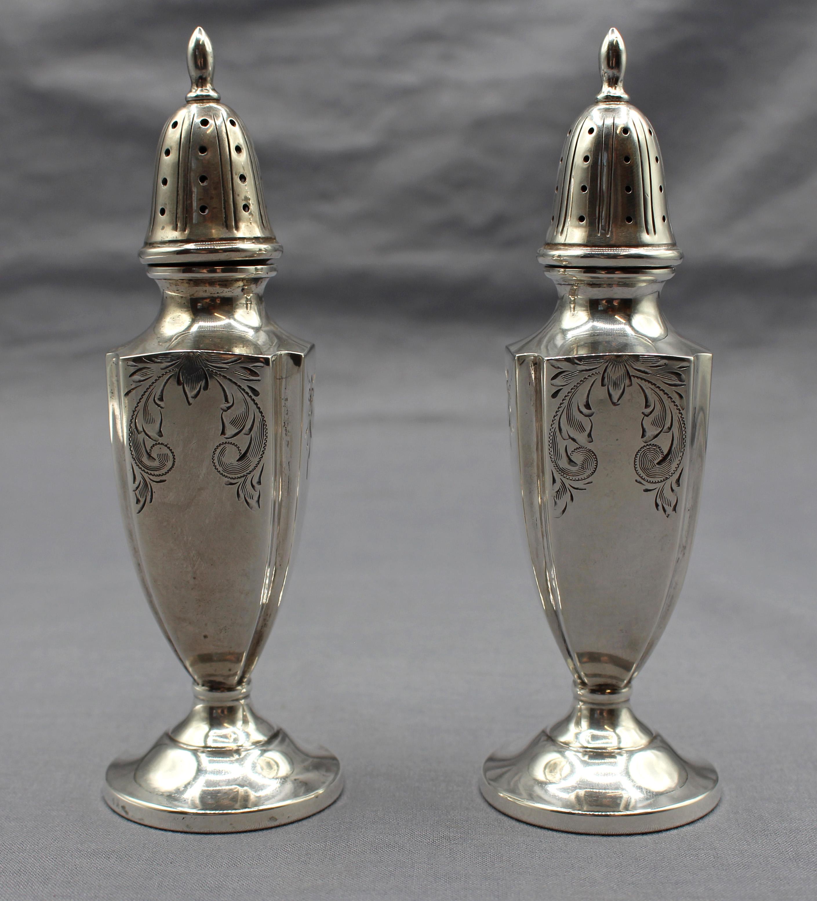 Vintage pair of sterling silver salt & pepper casters, Fisher Company, pattern 419. Neoclassical style. Never engraved. Bright cut designs. 3.10 troy ounces.

Measures: 5 1/2