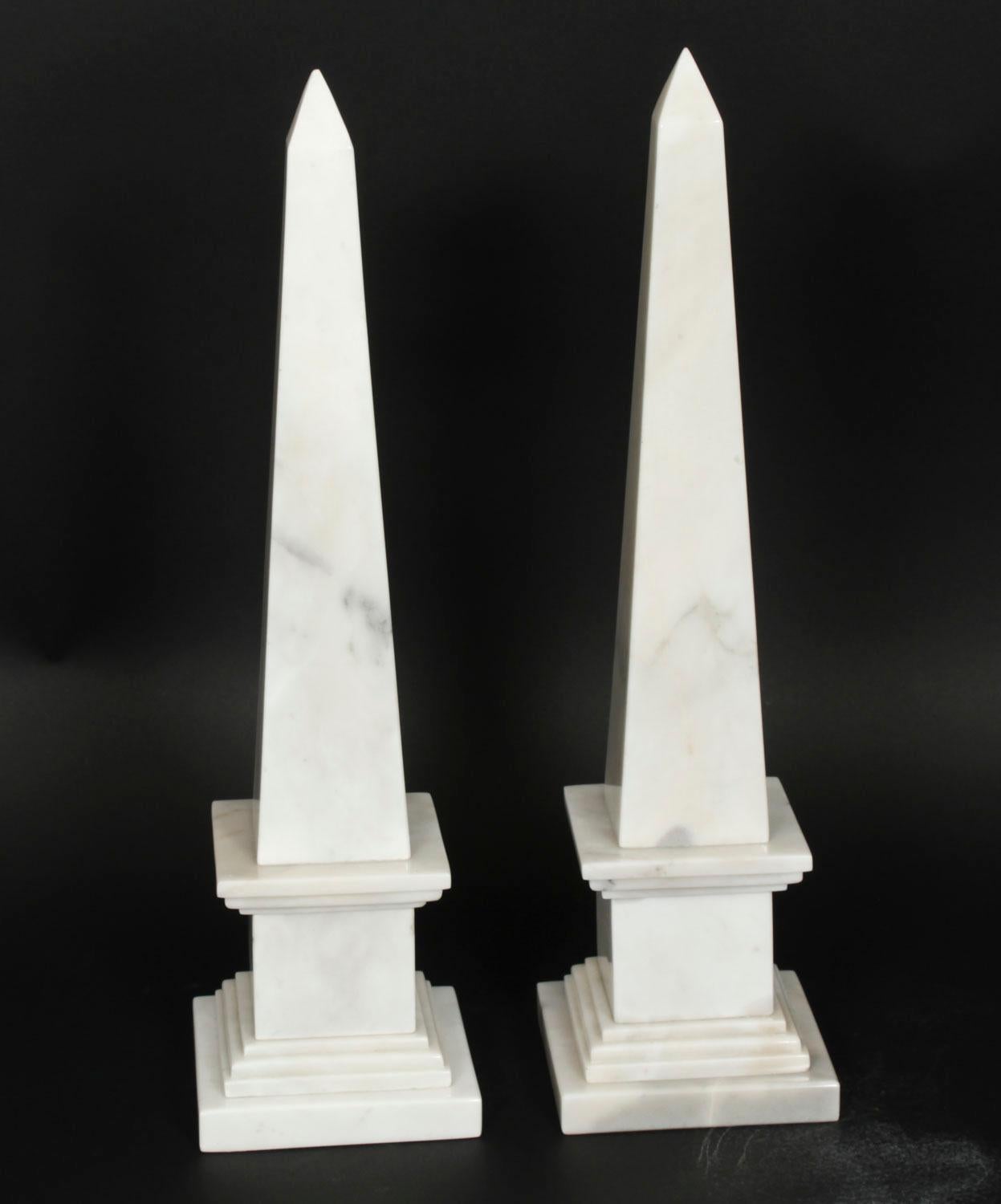 A stunning Vintage pair of large Empire Revival obelisks, dating from the late 20th Century.

They are made of beautiful white Carrara marble, the finish and attention to detail throughout are fantastic.

A truly stunning pair of display pieces.
