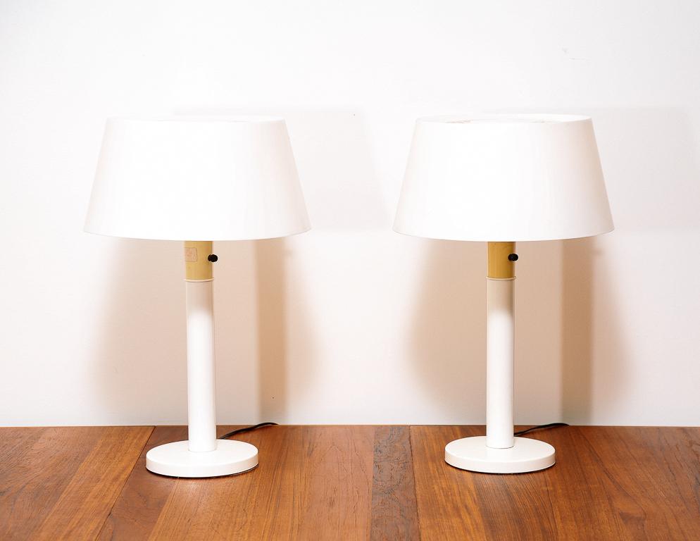 Pair of table lamps with white enameled steel base and white plastic diffuser. Designed by Gerald Thurston for Lightolier.