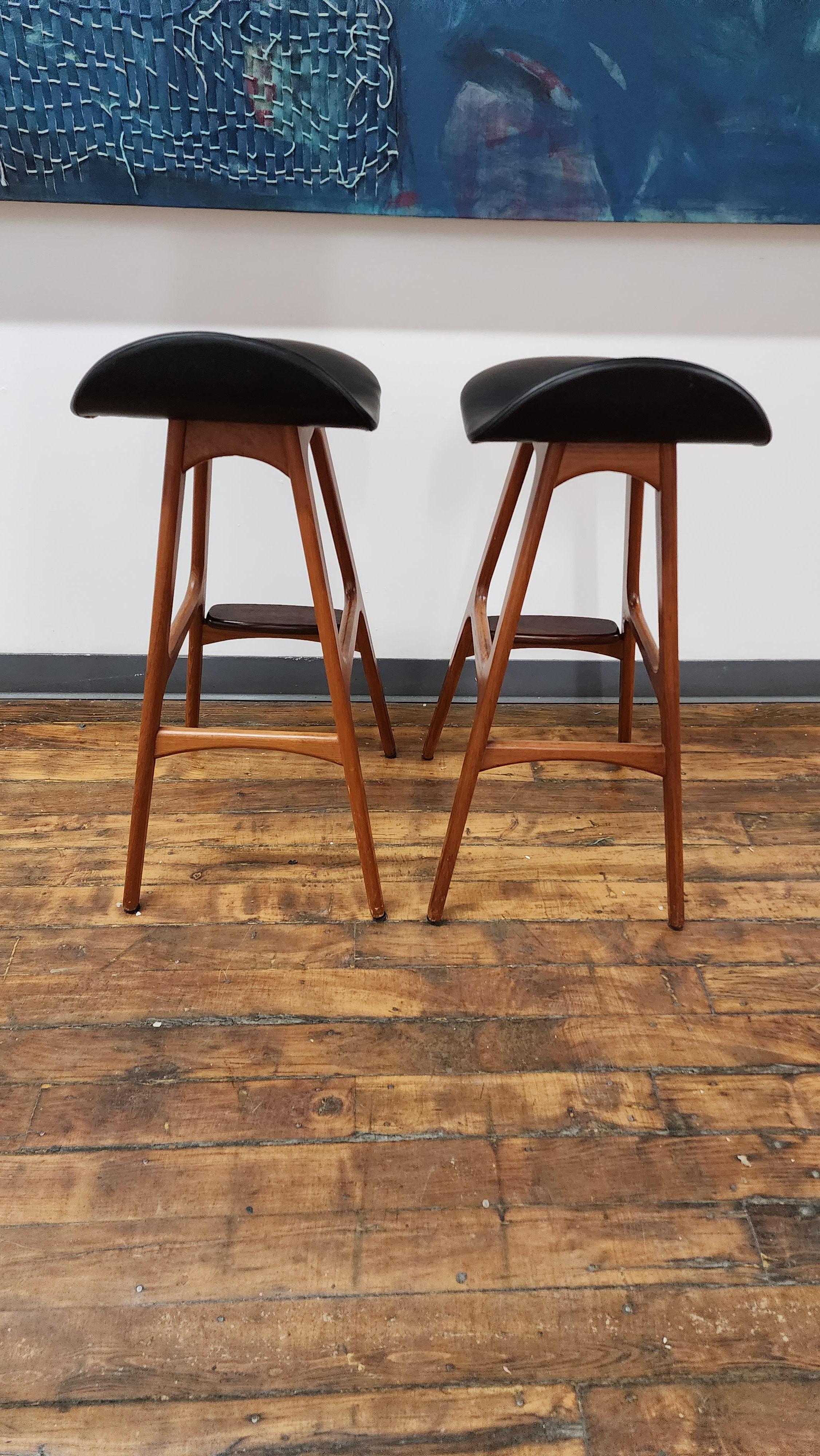 Beautiful Pair of Vintage Teak barstools by Erik Buch.  leather isnin great shape. features rosewood footrests.  2 pairs available. 