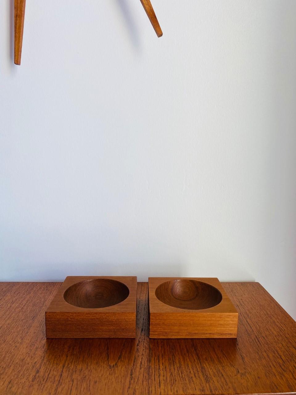 Beautiful pair of vintage teak wood bowls. These small wood vessels are minimalist in design. Of Japanese origin, the wood grain and design is linear and honest. Each square is immaculate in shape as a rounded indentation reveals itself in the