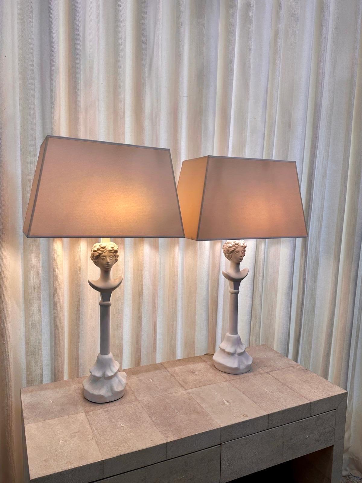 Wonderful pair of painted plaster Tête de Femme table lamps after the original by Alberto Giacometti, designed circa 1930's. A classic design with singular presence - the two lamps have slightly different finishes, one more matte finish than the