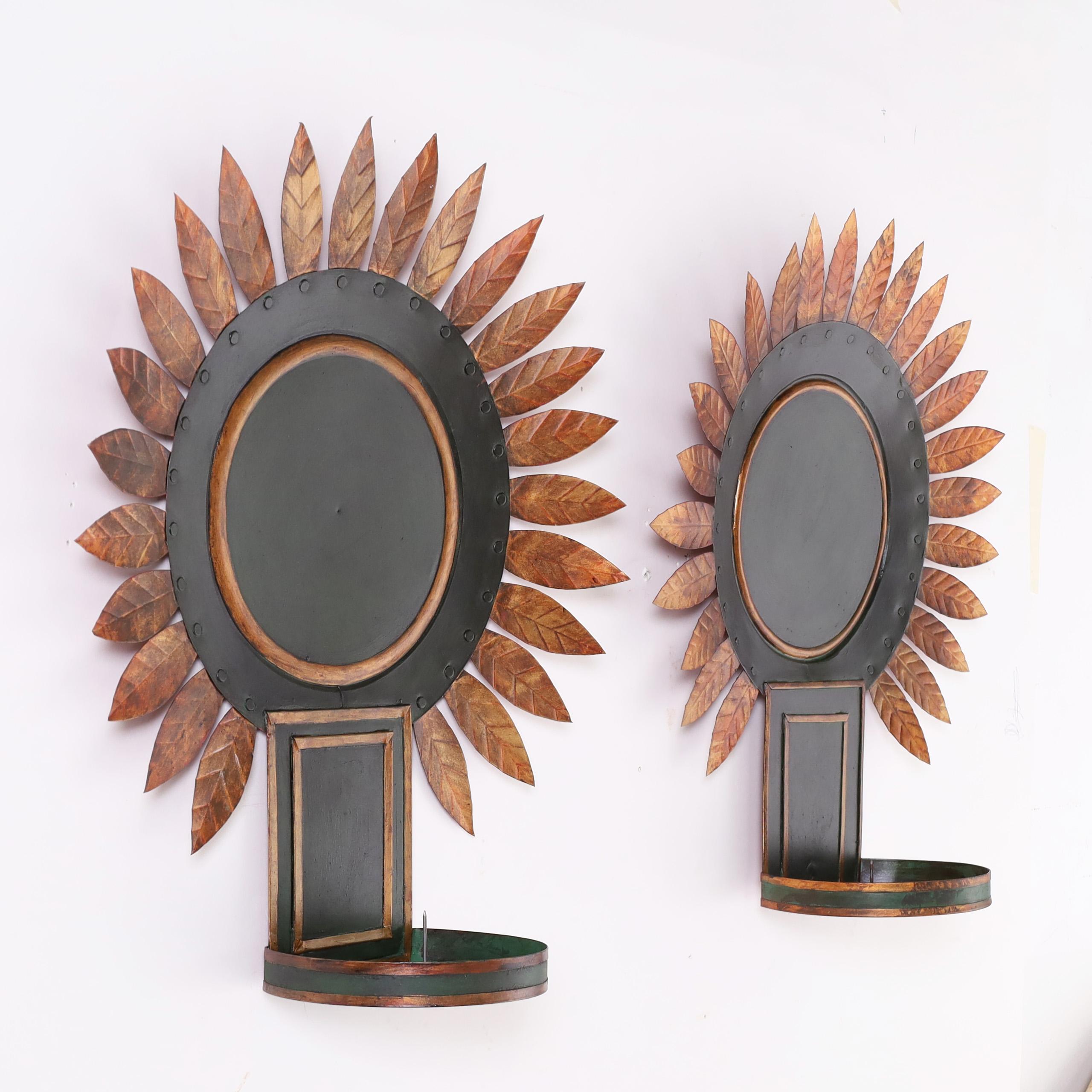 Encantadora pareja de apliques de pared de hojalata en forma de rayos de sol dorados alrededor de un sol verde y un candelabro con adornos dorados. Firmado Briger Design New York en los dorsos. No electrificada. 
