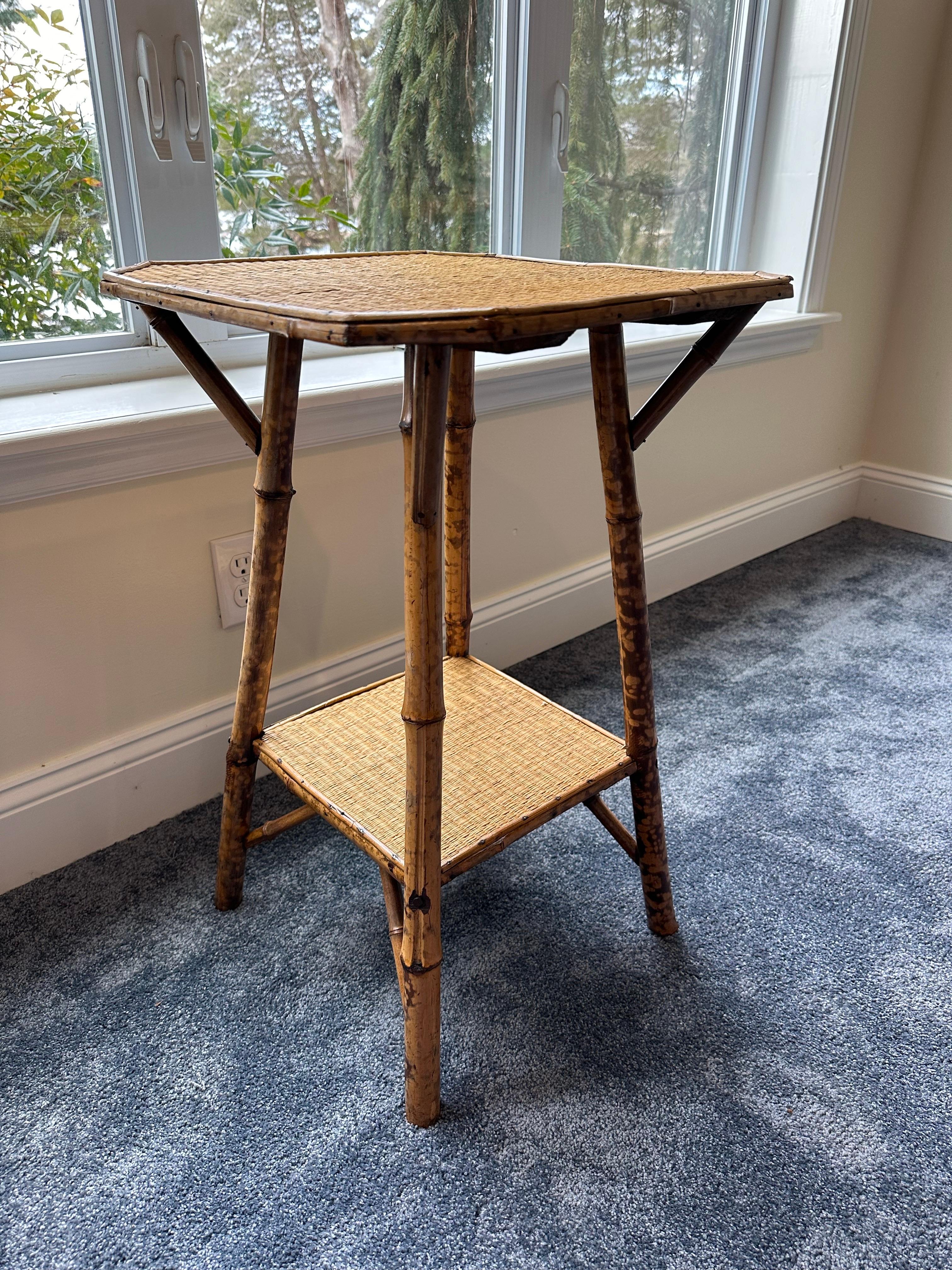 Beautiful pair of coordinating tortoise shell bamboo and rattan side tables. One table features a square shaped top while other features hexagonal top. The tables are a modern take on a traditional British Colonial design. Would work well in a