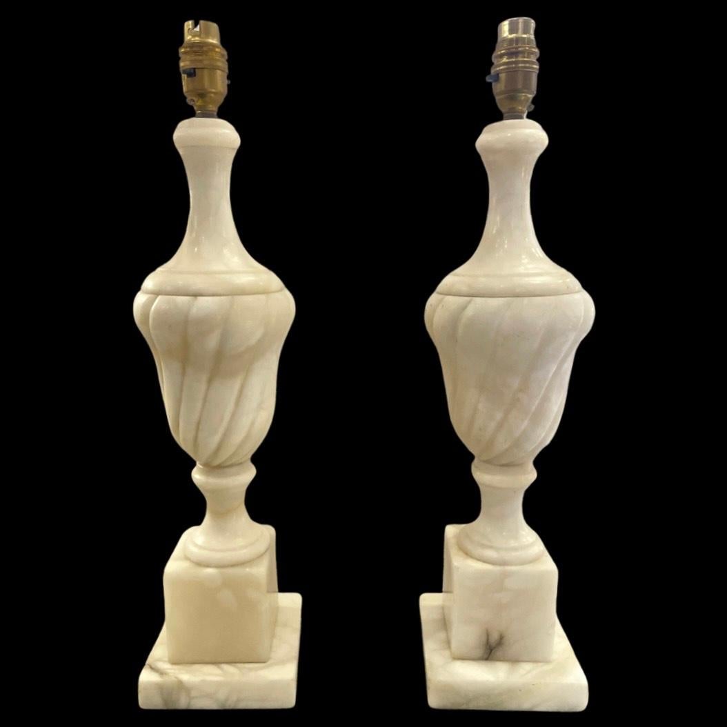 Elevate your living space with the timeless elegance of these exquisite Vintage White Alabaster Neoclassical Table Lamps, hailing from 19th-century Italy. Crafted with precision, the lamps boast a stunning twist detail, each groove meticulously