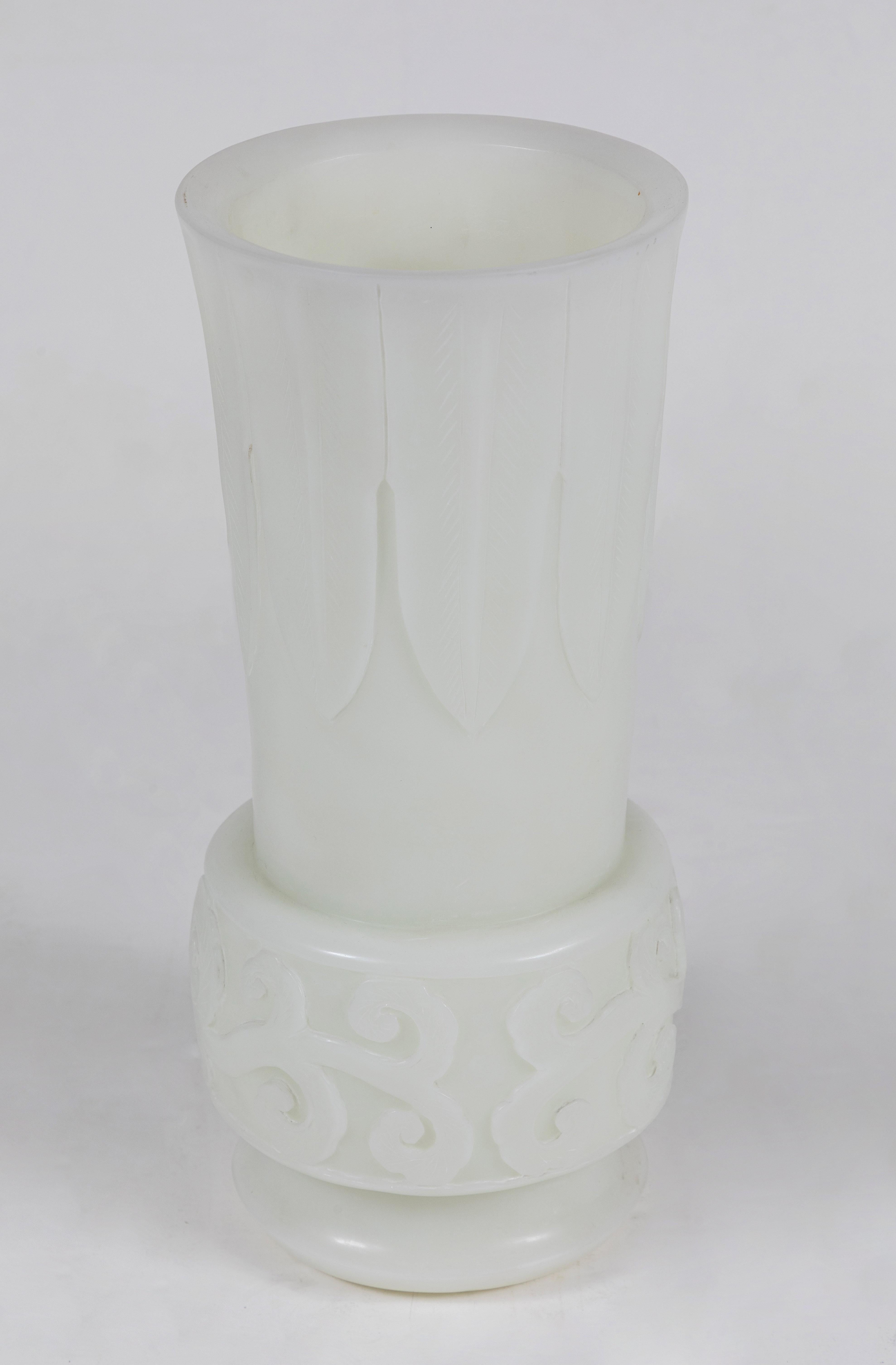 A beautiful pair of hard-to-find, Republic Period, 1930s, white Peking glass urns with foliate details throughout.