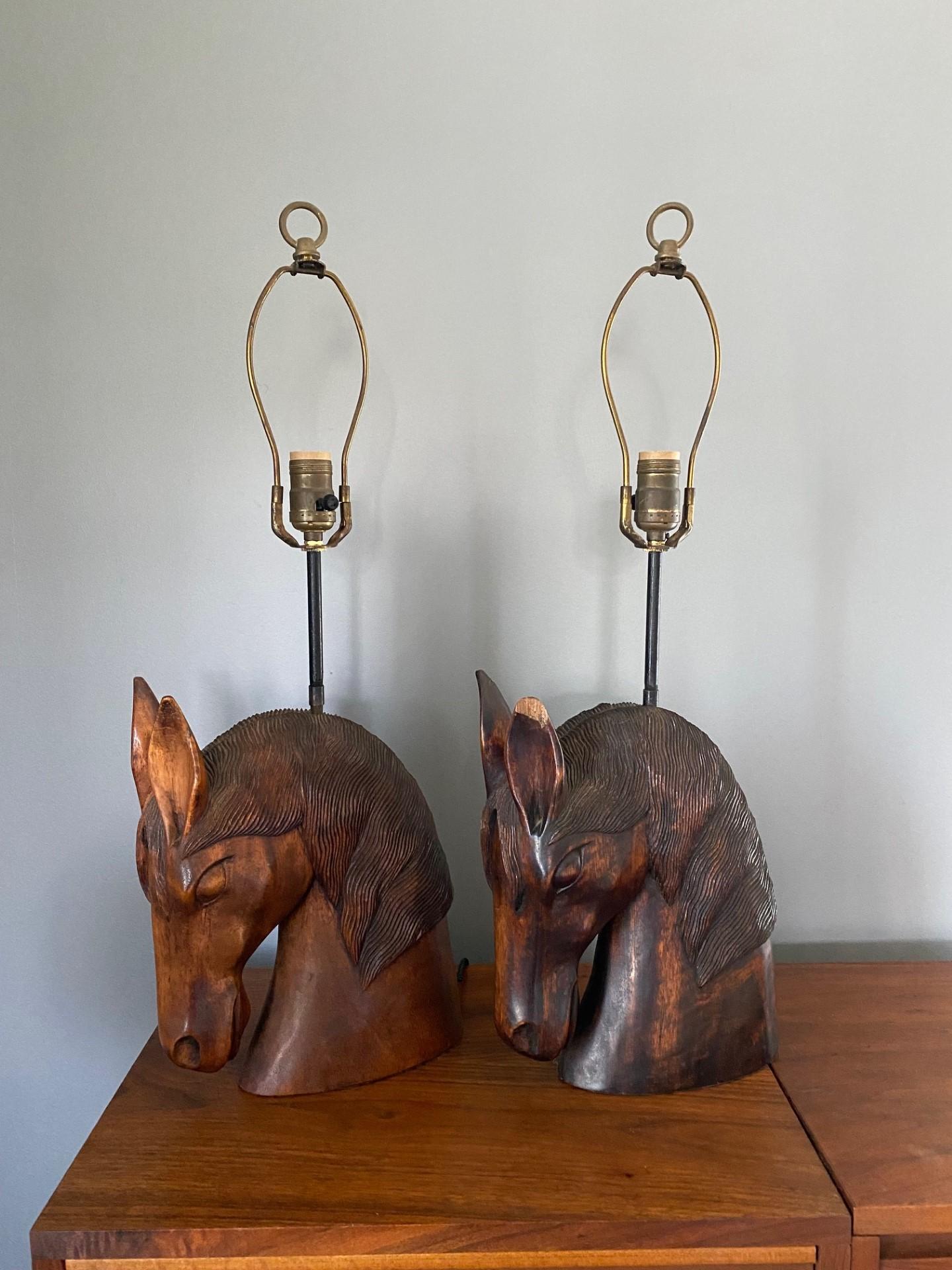 Pair of William Billy Haines carved horse head lamps. This is a unique and stunning pair for of lamps that can complement a variety of different styles. From midcentury to modern, to organic. The horse heads are beautifully carved and seamlessly
