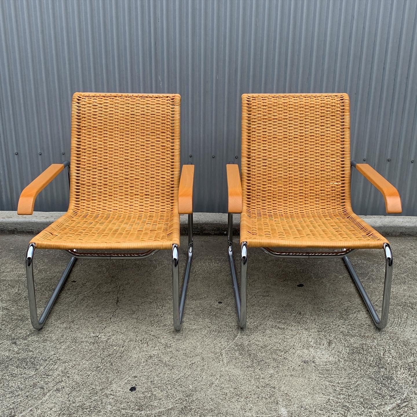 Incredible pair of B35 lounge chairs by Marcel Breuer. This pair is featured with original woven caning, chrome cantilever frame and beechwood armrests. Original ICF stickers can be found underneath the seat with 