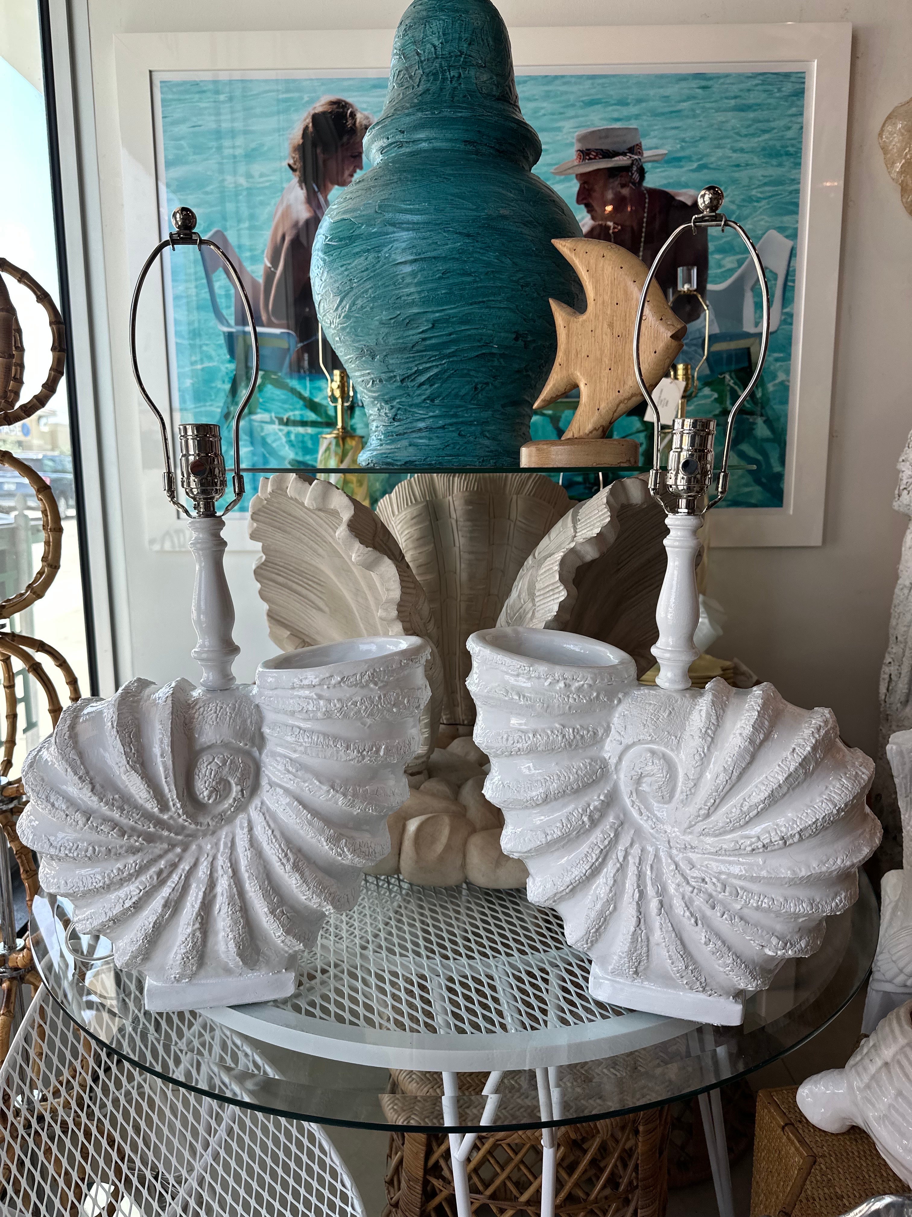 Pair of large opposing 1970s vintage nautilus seashell shell plaster table lamps. No chips or breaks. Newly lacquered in a clean white. Newly wired, clear cord, 3 way nickel sockets and hardware. Dimensions; 25 H to top of finial x 18.5 H to top of