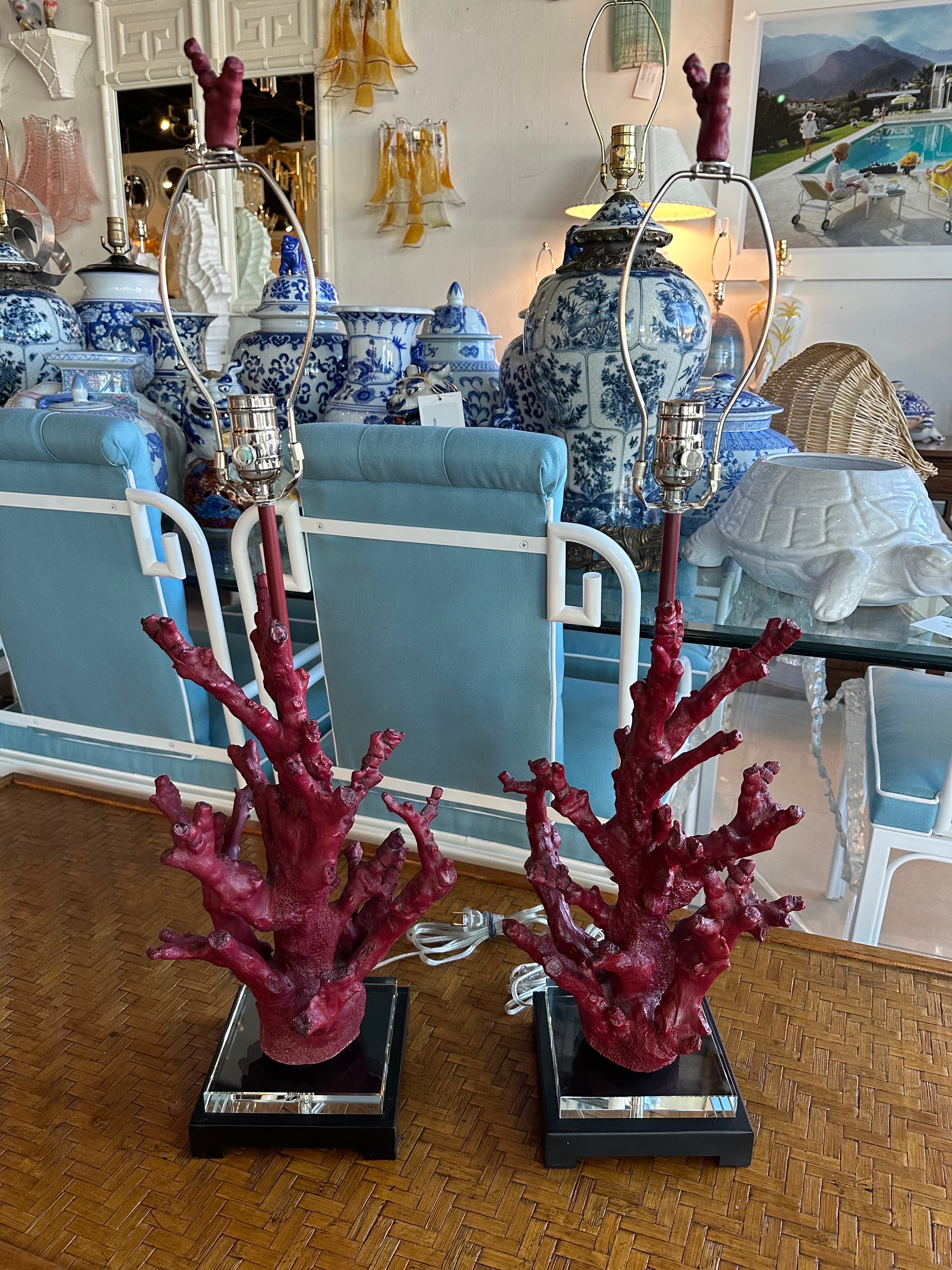 Lovely pair of vintage faux red coral table lamps with lucite and metal base. These have been newly wired with clear cord, 3 way nickel sockets and harp, original matching coral finial. Dimensions: 32 H (to top of finial) x 23 H (to lamp socket) x