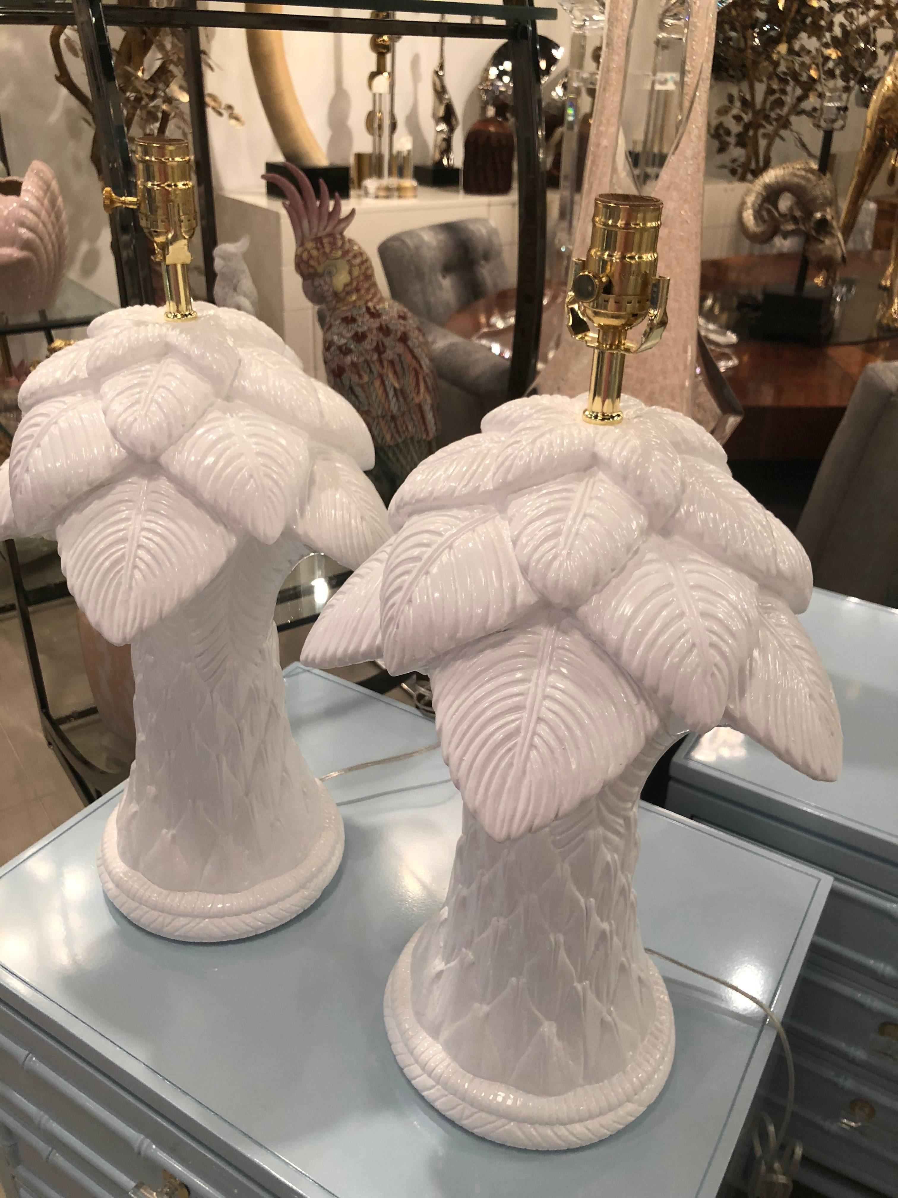Amazing pair of vintage plaster palm tree frond leaves leaf table lamps. These have meticulously restored. Professionally lacquered in a white gloss finish. Newly wired with new brass hardware. These are very heavy. Additional matching pair