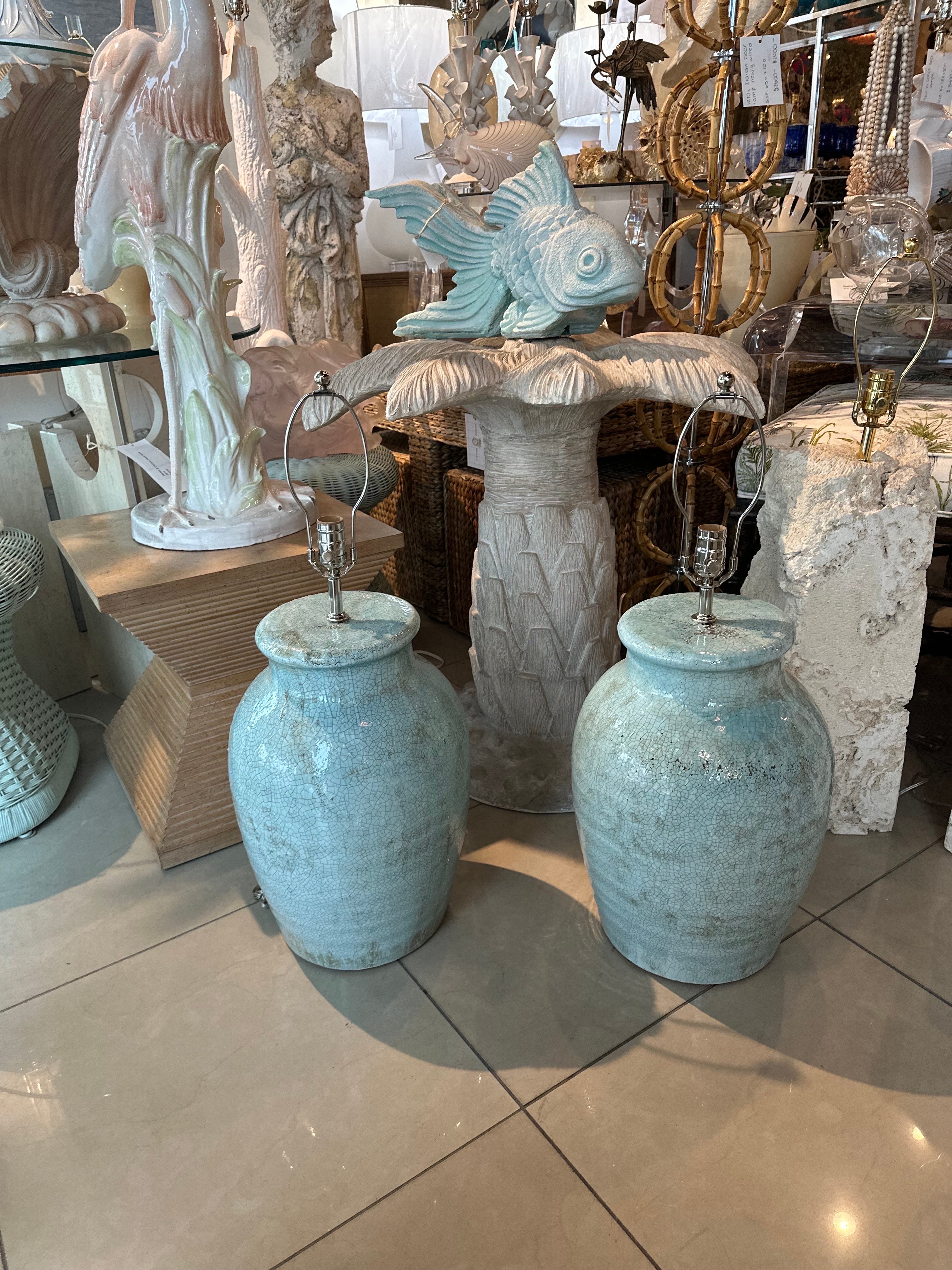 Vintage large pair of terra cotta glazed crackle porcelain finish in a beautiful soft light minty green color. No chips or breaks. These have been newly wired with clear cords, 3 way sockets, all new nickel hardware. Dimensions: 29 H to top of