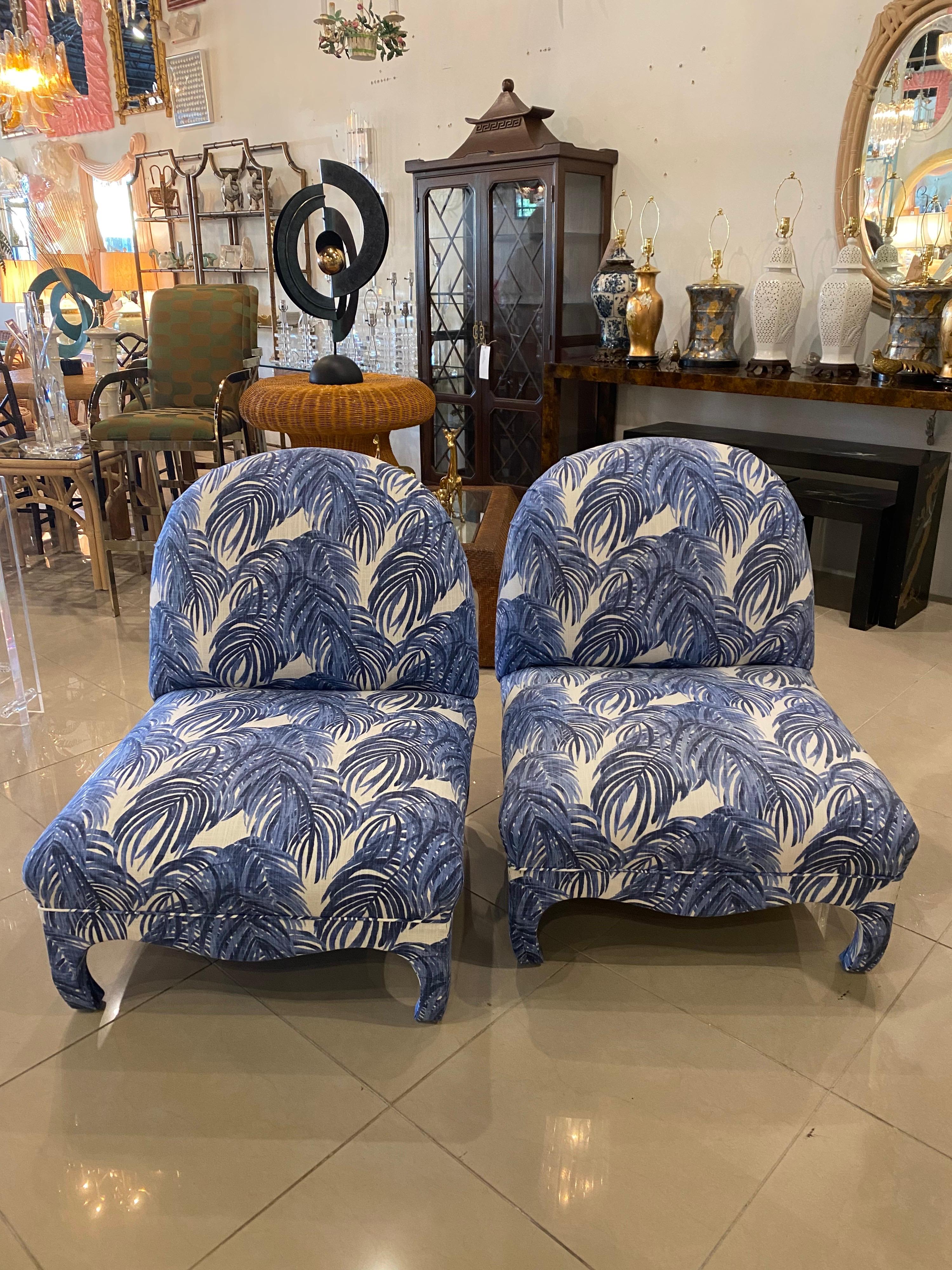 The most amazing pair of vintage slipper chairs. These have been newly upholstered in a linen blend blue and white palm leaf fabric. The feet are all ming and there is scalloped edges all the way around. These chairs could float in a room and look
