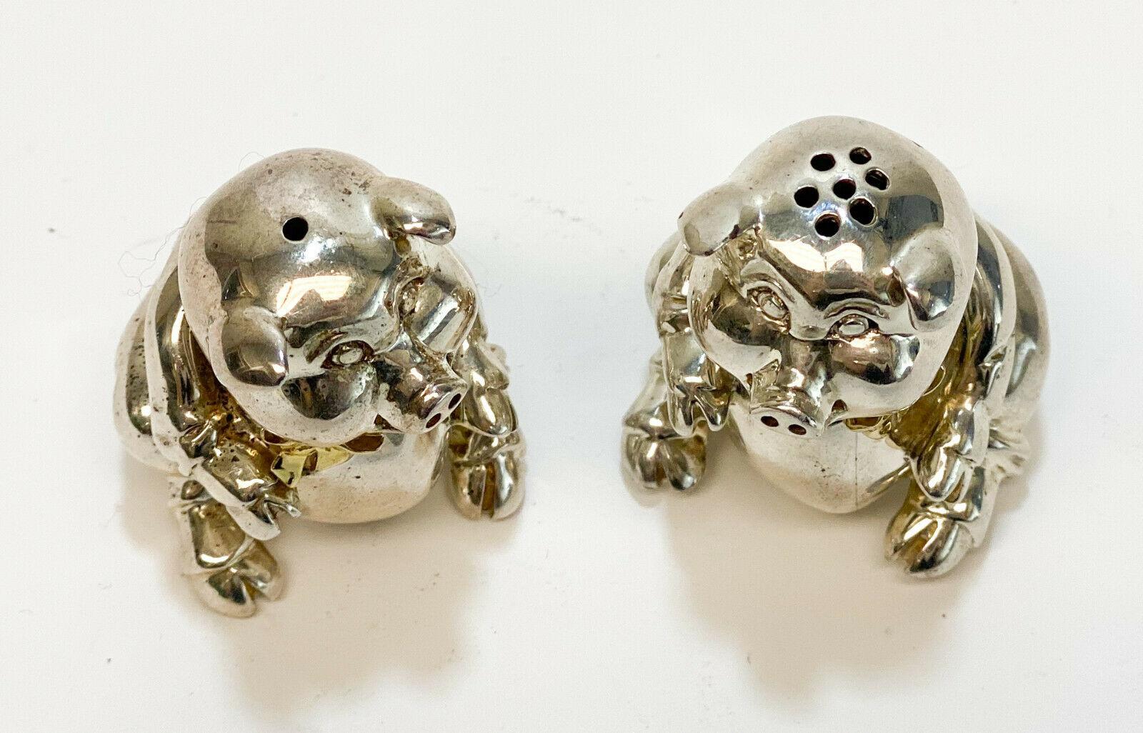 Vintage pair of Tiffany & Co. sterling silver figural pig salt and pepper shakers. Gilt bow ties Tiffany marks to the underside and marked 