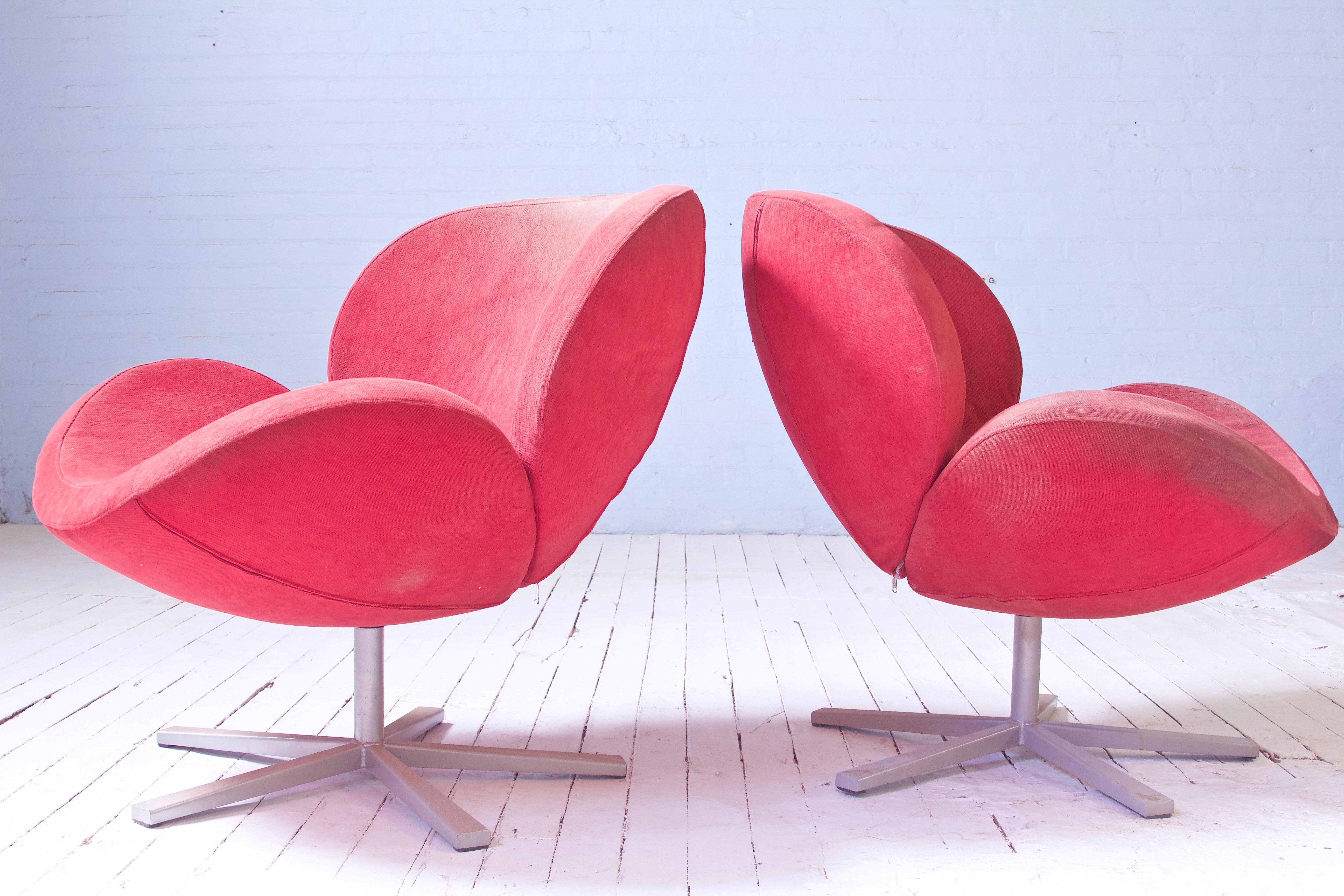 A lovely pair of tulip style swivel base lounge chairs in the manner of Pierre Paulin. Foam is soft and pliable, frames are sound and strong and swivel perfectly . The upholstery zip covers are soiled in some areas(see images), but can be machine