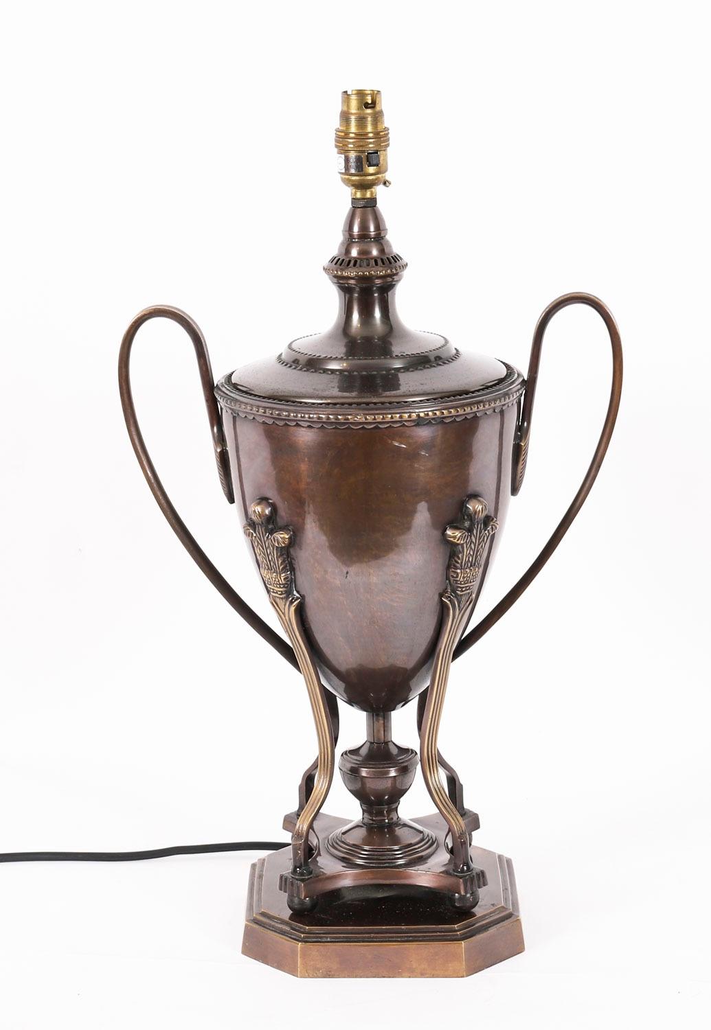 A superb vintage pair of bronze classical urn shaped lamps, late 20th century in date.

This striking pair of reeded twin handled bronze Kantharos urns feature decorative feathered crown supports on Quadro-pod tiers and shaped stepped bases.

This