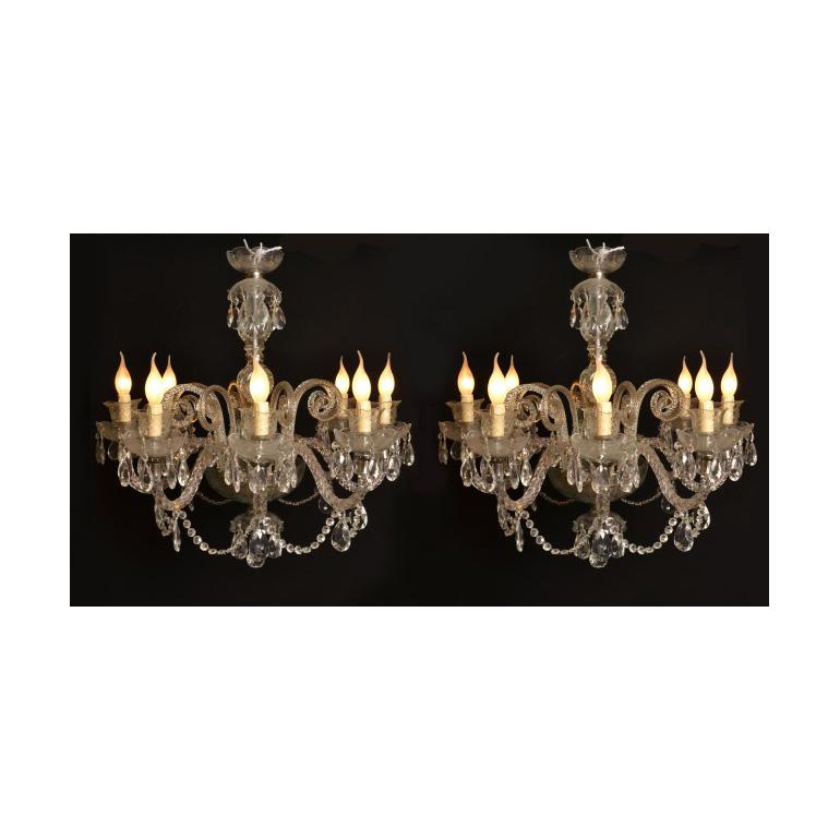 This is a stunning vintage pair of Venetian style crystal chandeliers with eight lights, dating from the second half of the 20th Century.

Add an elegant touch to your home with this beautiful pair of highly decorative chandeliers.

Condition:
They