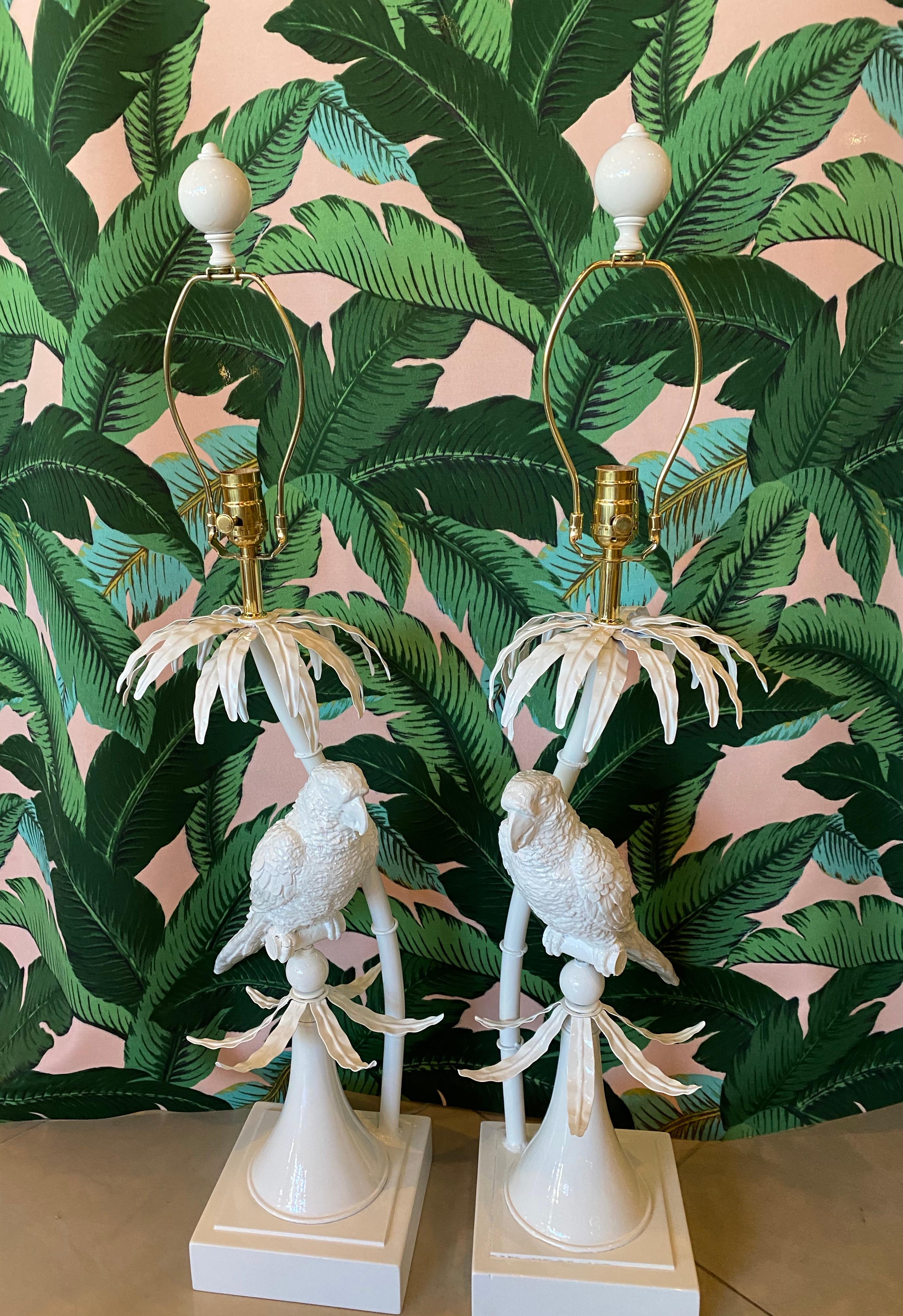 Such an amazing pair of vintage parrot bird, tropical leaves table lamps newly lacquered in white. Newly wired, new brass hardware. 

Measures: Height to socket 28
