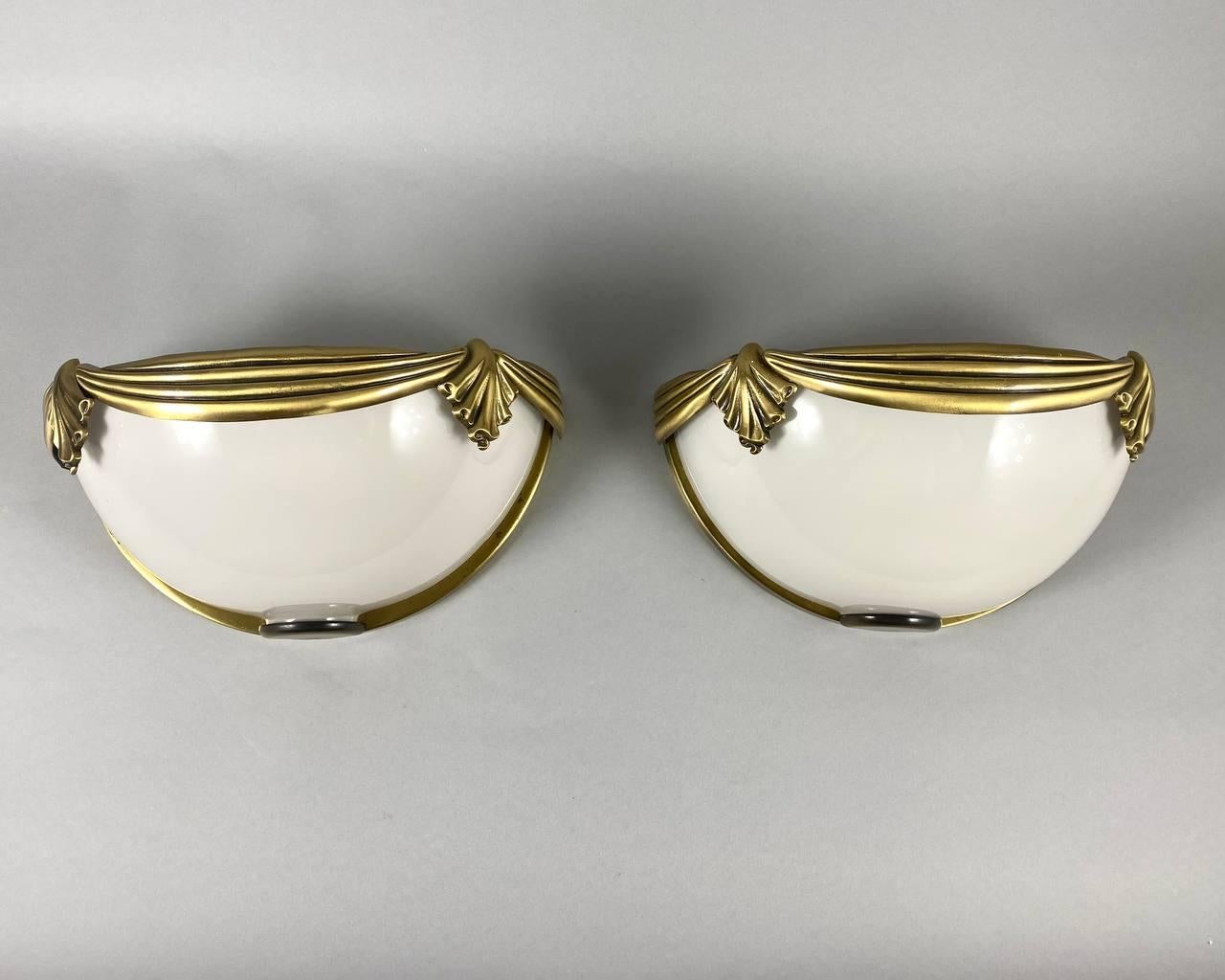 Vintage wall sconces made of authentic opaline glass and brass.

From Spanish Manufacturer Cuenca Iluminacion S.A.

circa 1980s. Spain.

Rare and sophisticated pair of Spanish Wall Sconces. 

Each lamp has a handsome gilt brass frame where