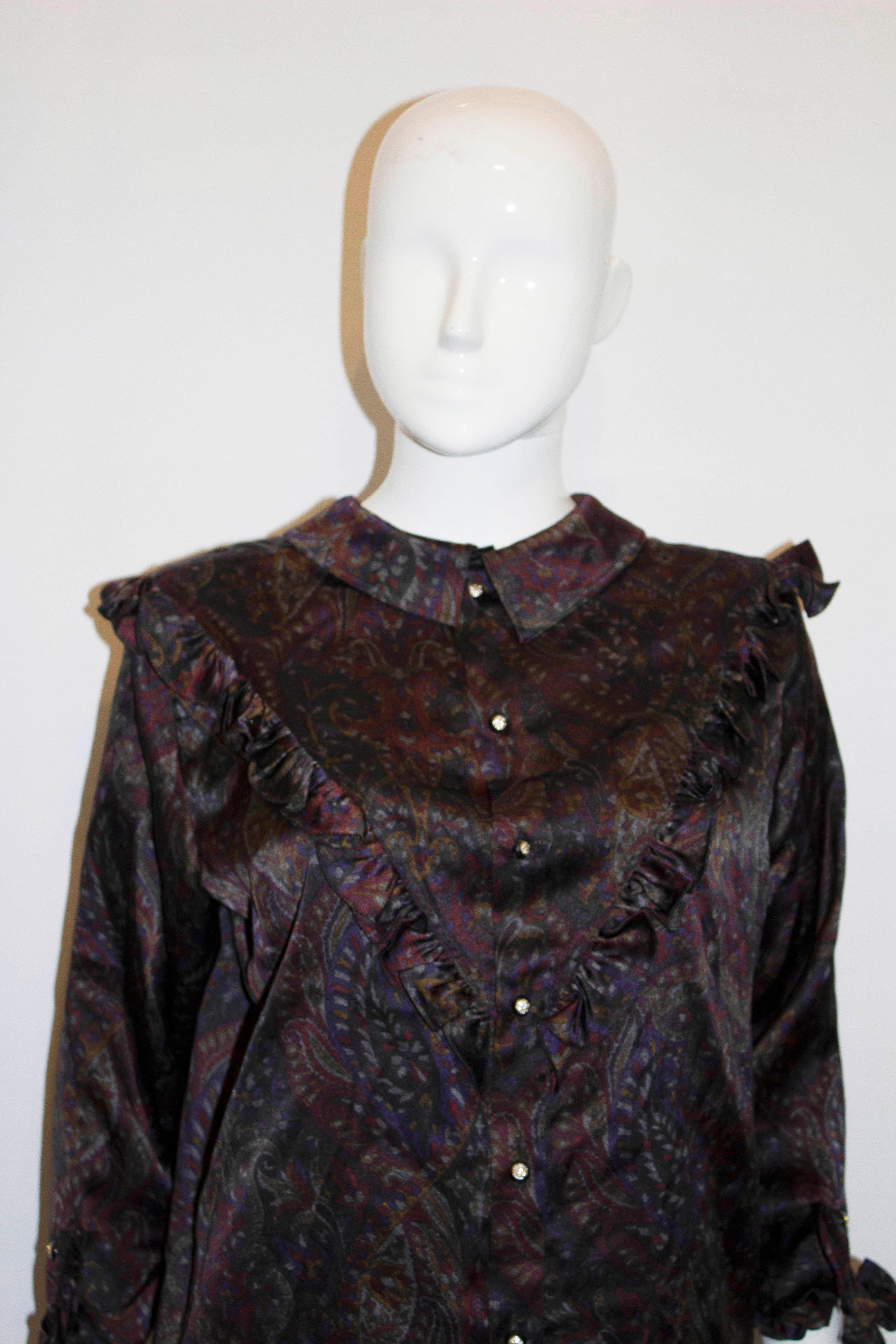 A great vintage Italian silk shirt by Gruppo 9724. The shirt has an interesting and unusual collar enabling it to be worn, front or back.  It has a front button opening with ruffle and decoration and double cuff. Measurements: Bust up to