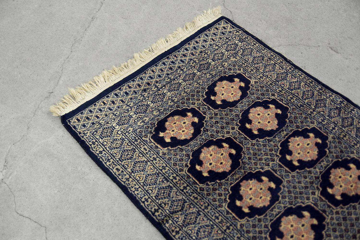 This hand-woven oriental carpet was made in Pakistan during the 1960s for Ikea. Traditionally flat woven and dyed in shades of navy blue and beige. It was woven using natural wool and cotton. Due to the appropriate treatment, the wool has a