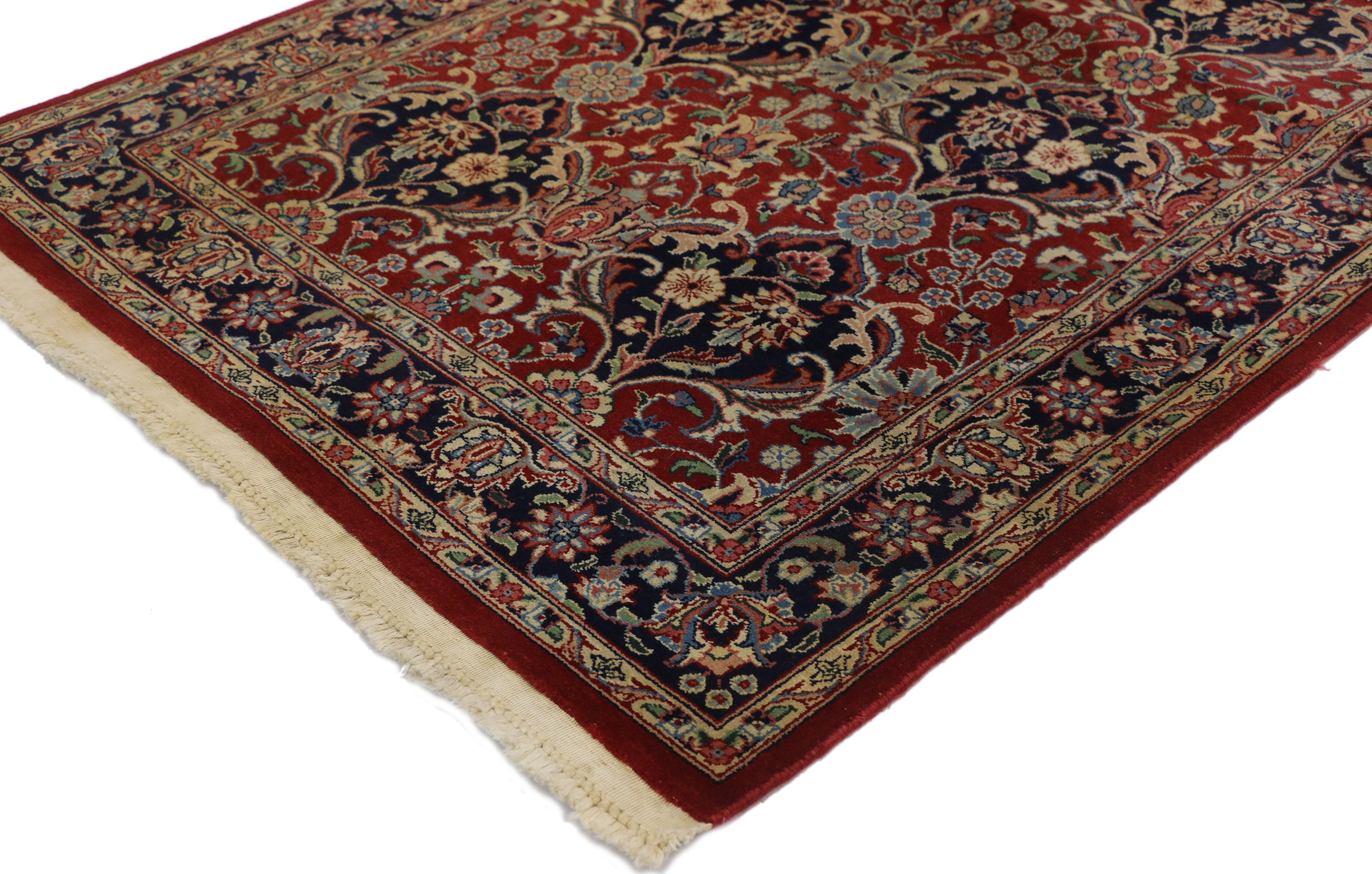 74301 Vintage Pakistani Rug with Floral Bouquets and Persian Design. Eight floral bouquets with navy blue halos grace a bright red field in this tastefully detailed Pakistani rug. Within the all-over pattern round florets appear at intervals and