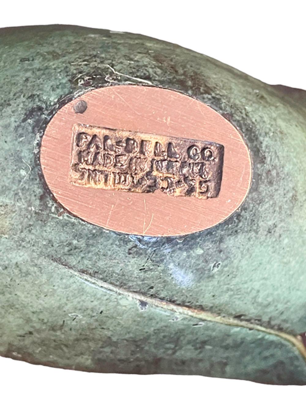 Vintage cast and patinated cigar / cigarette ashtray by Pal-Bell in the form of a swan with wings partially open and its head turned back over its back.