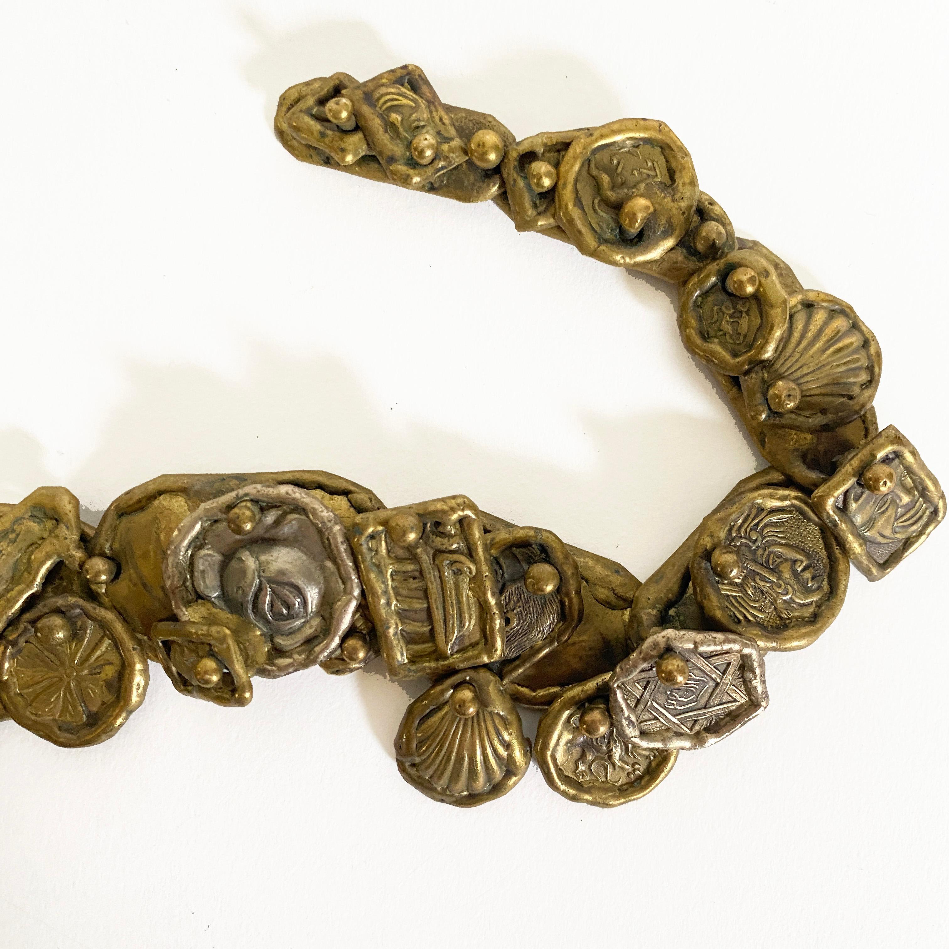 Vintage Pal Kepenyes bronze/brass necklace, 20th century. 

This Hungarian born artist worked in Mexico for decades, known for free-form sculptural jewelry. Faces, insects and what-nots make up the figurative detail of this necklace. His signature