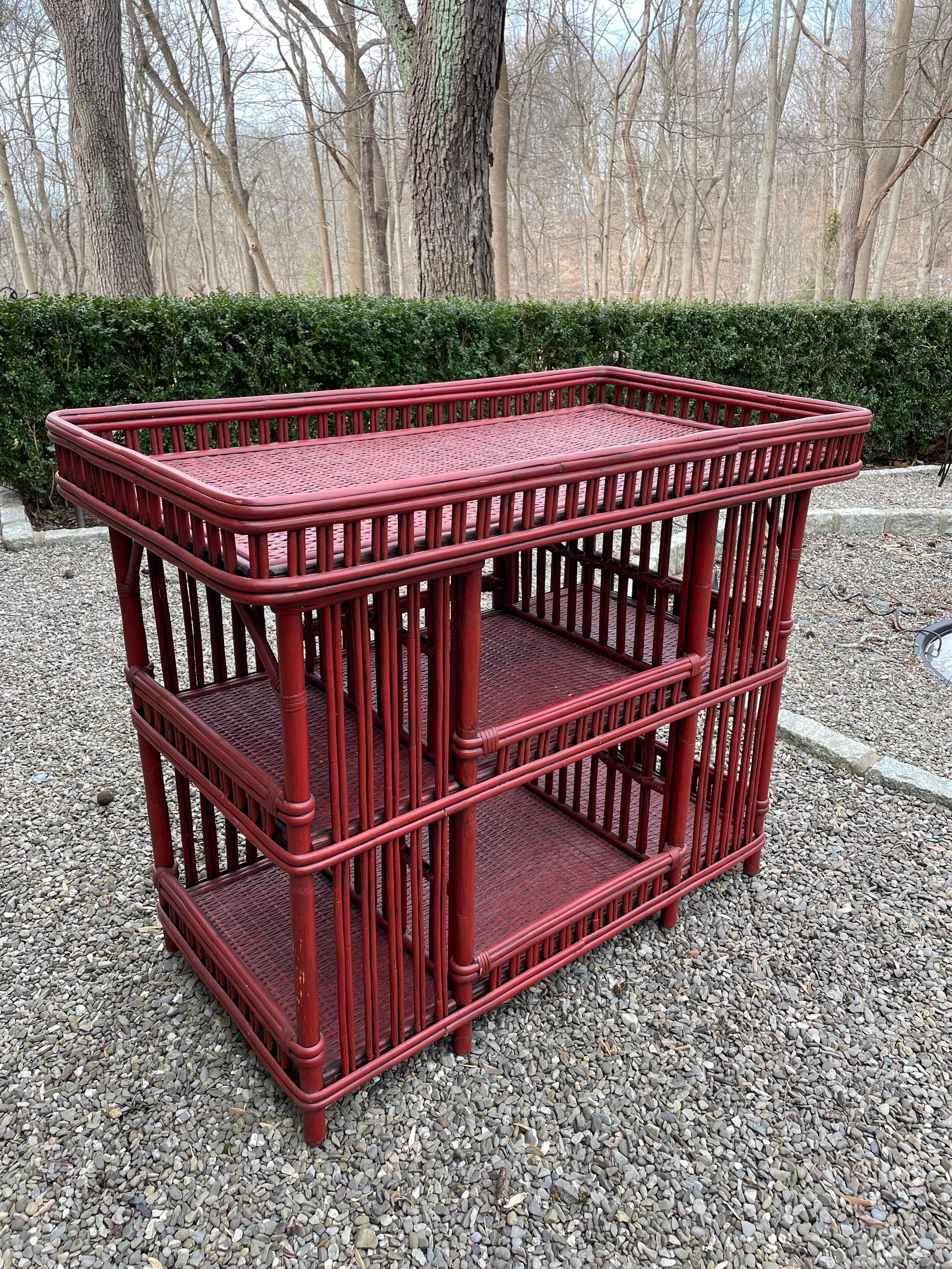 Versatile vintage rattan bar cart of server in a great red brick color. Three tiers offer multiple areas for bottles, appetizers, etc.