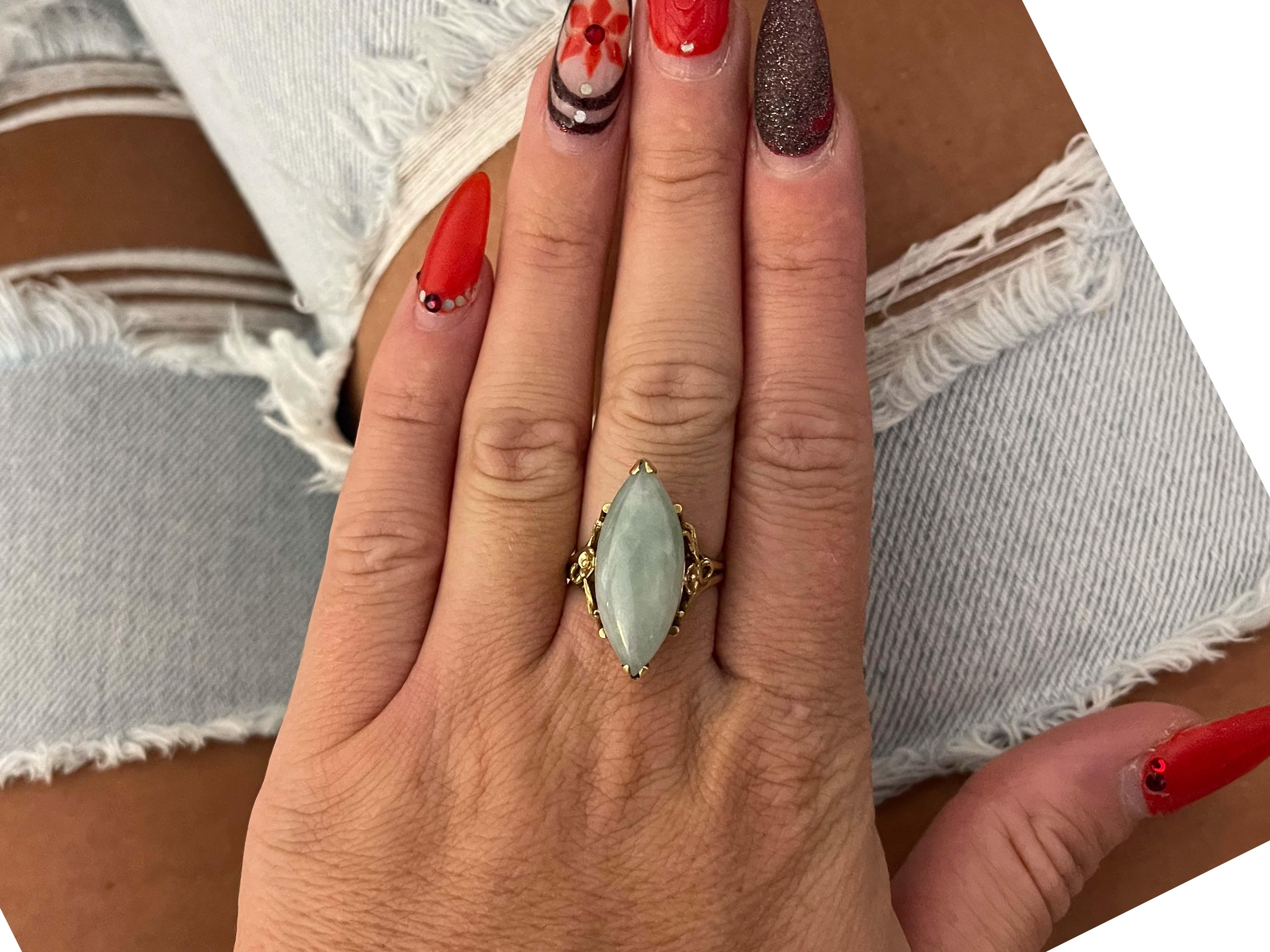 Item Specifications:

Metal: 14K Yellow Gold

Style: Statement Ring

Ring Size: 7.25 (resizing available for a fee)

Total Weight: 7.19 Grams

Ring Height: 25 mm

Gemstone Specifications:

Gemstone: Jade

Shape: Novette
​
Jade Measurements: 25mm x