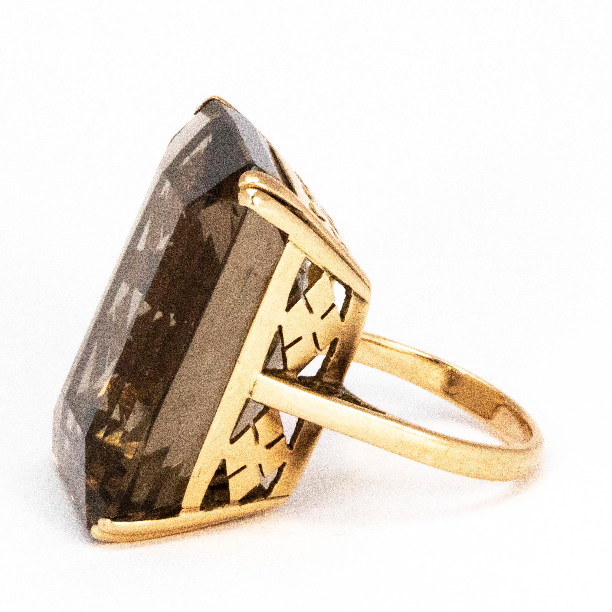 The stone at the centre of this gorgeous cocktail ring is very very large. It is a definite statement piece! The stone is emerald cut and is set in 9ct gold and is held with double claws at each corner. The underside of the setting is decorative