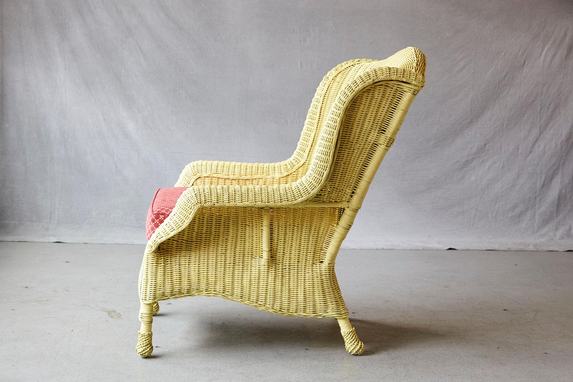 Summer and the living is easy, beautiful vintage Cape Cod wicker fauteuil in pale yellow paint, rolled arms, wrapped feed and a comfortable cushion upholstered in Pierre Deux fabric.
There are a few tiny paint chips, please refer to the detailed